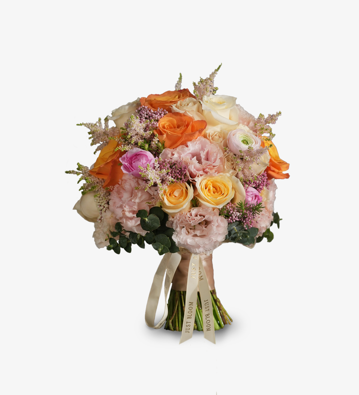 Colorful flower arrangement in a glass vase featuring orange Ecuadorian roses, Canterbury bells, giant alliums, and spring pastels beside books.