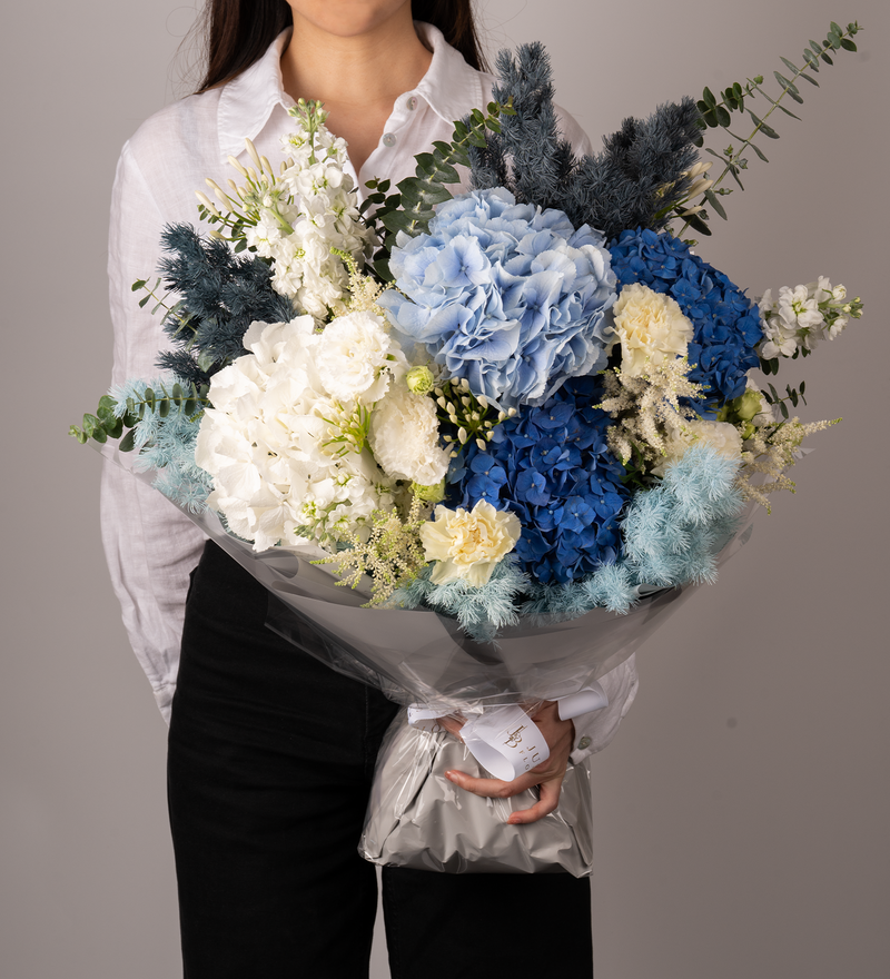 Just Bloom Stunning Fresh Flower Bouquet - Premium Dutch Hydrangeas, Stocks, Eustomas, Astibles, Asparagus Myriocladus, and Dutch Eucalyptus in Captivating Blue