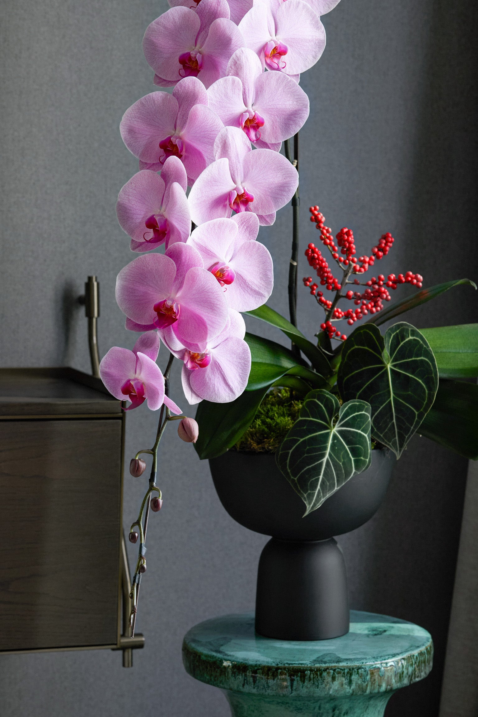 
Year of the Horse elegant pink orchid with crimson berries and tropical foliage Chinese New Year minimalist arrangement Hong Kong