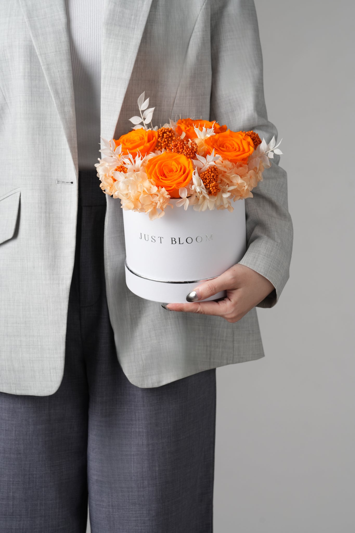 Sabina preserved flower hatbox with orange roses and neutral-toned fillers