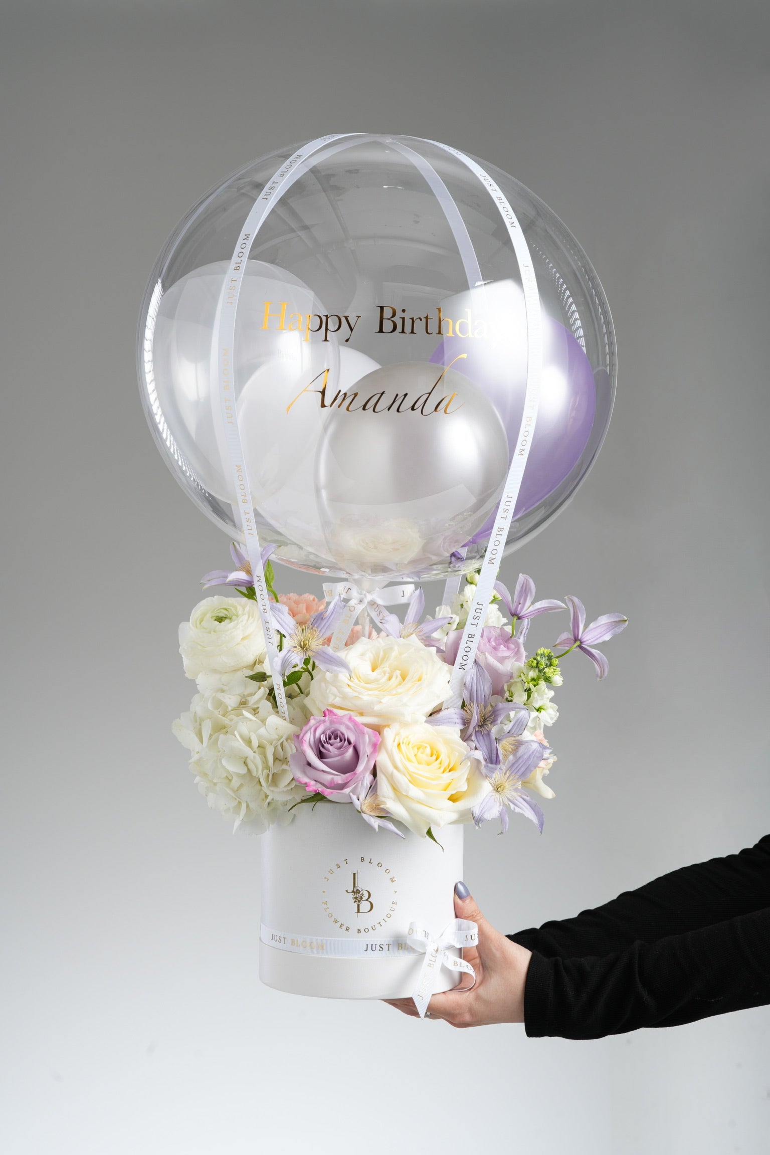 Samara birthday hot air balloon flower box with soft purple and white blooms