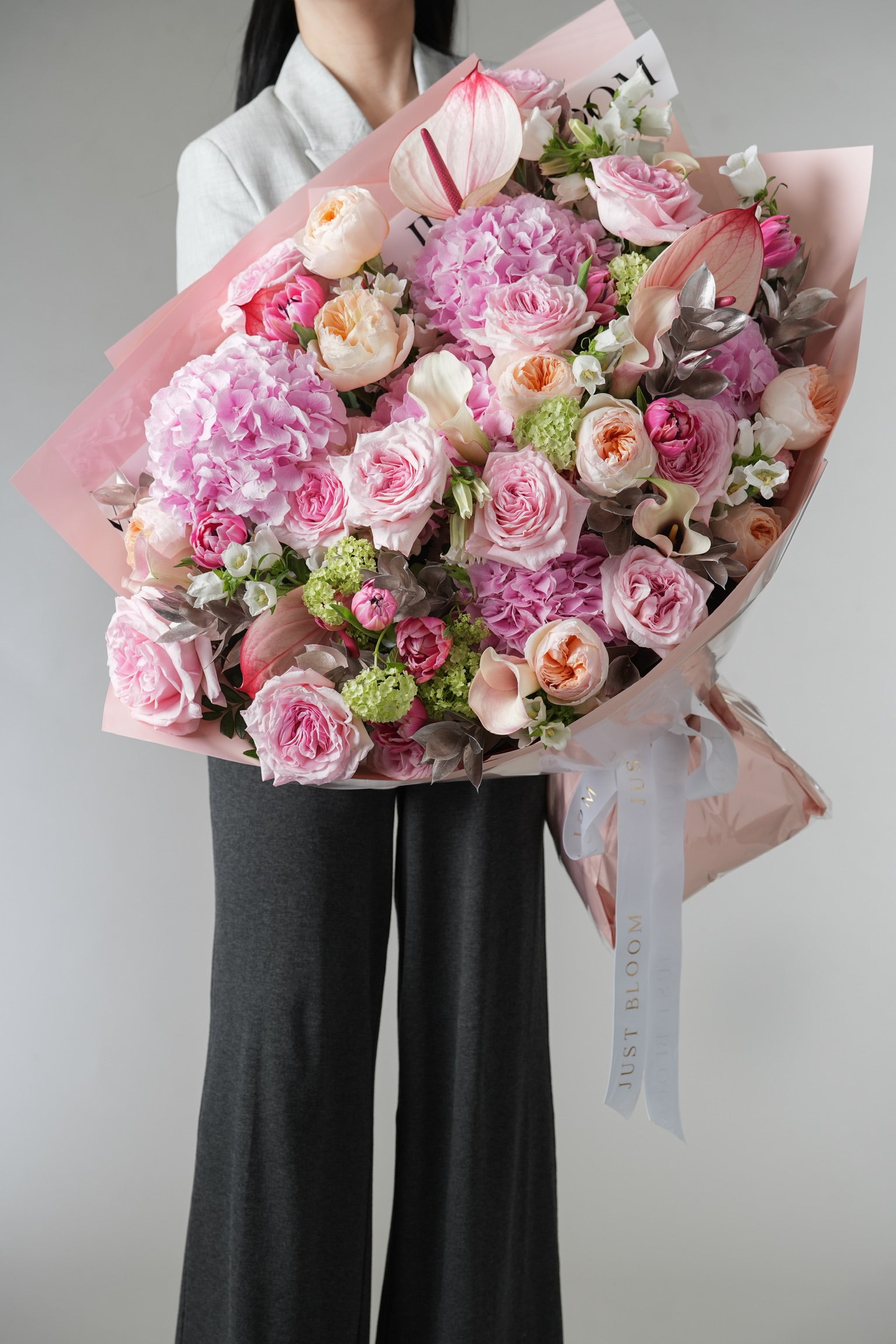 Amoura bouquet with pink roses, hydrangeas, and anthuriums in soft pastel tones