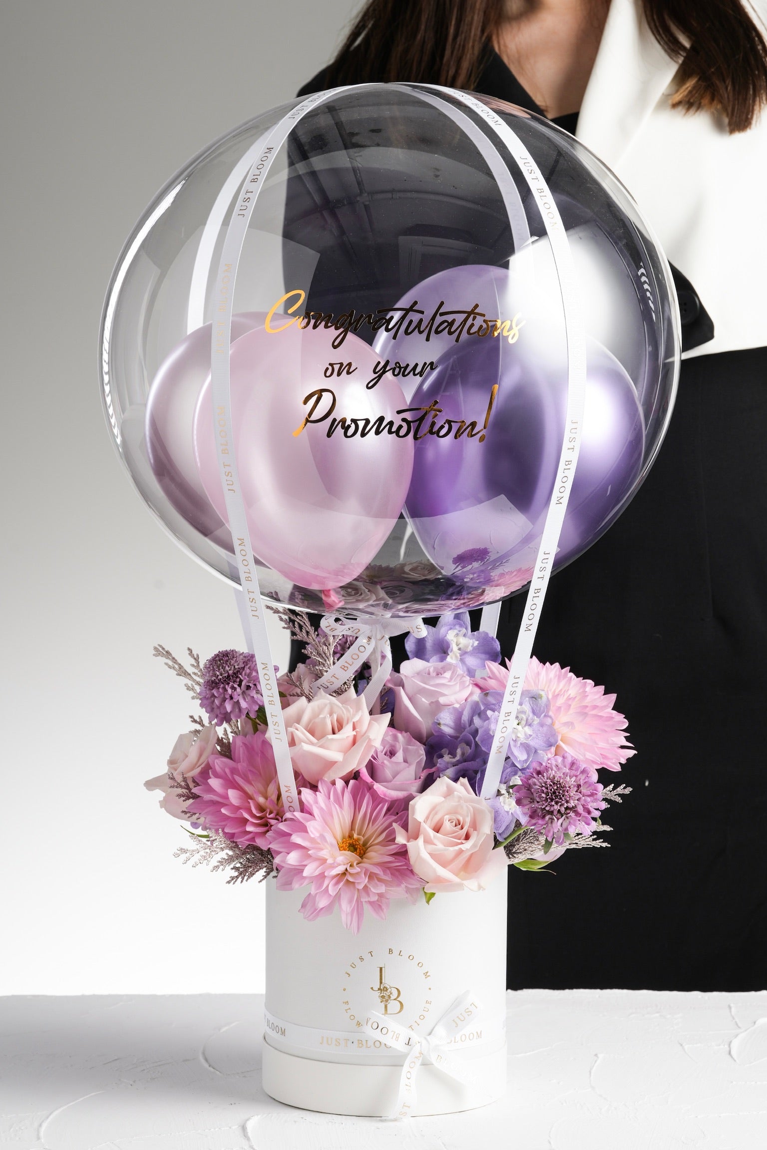 Top-down view of Angie flower box with ribbon and floral textures