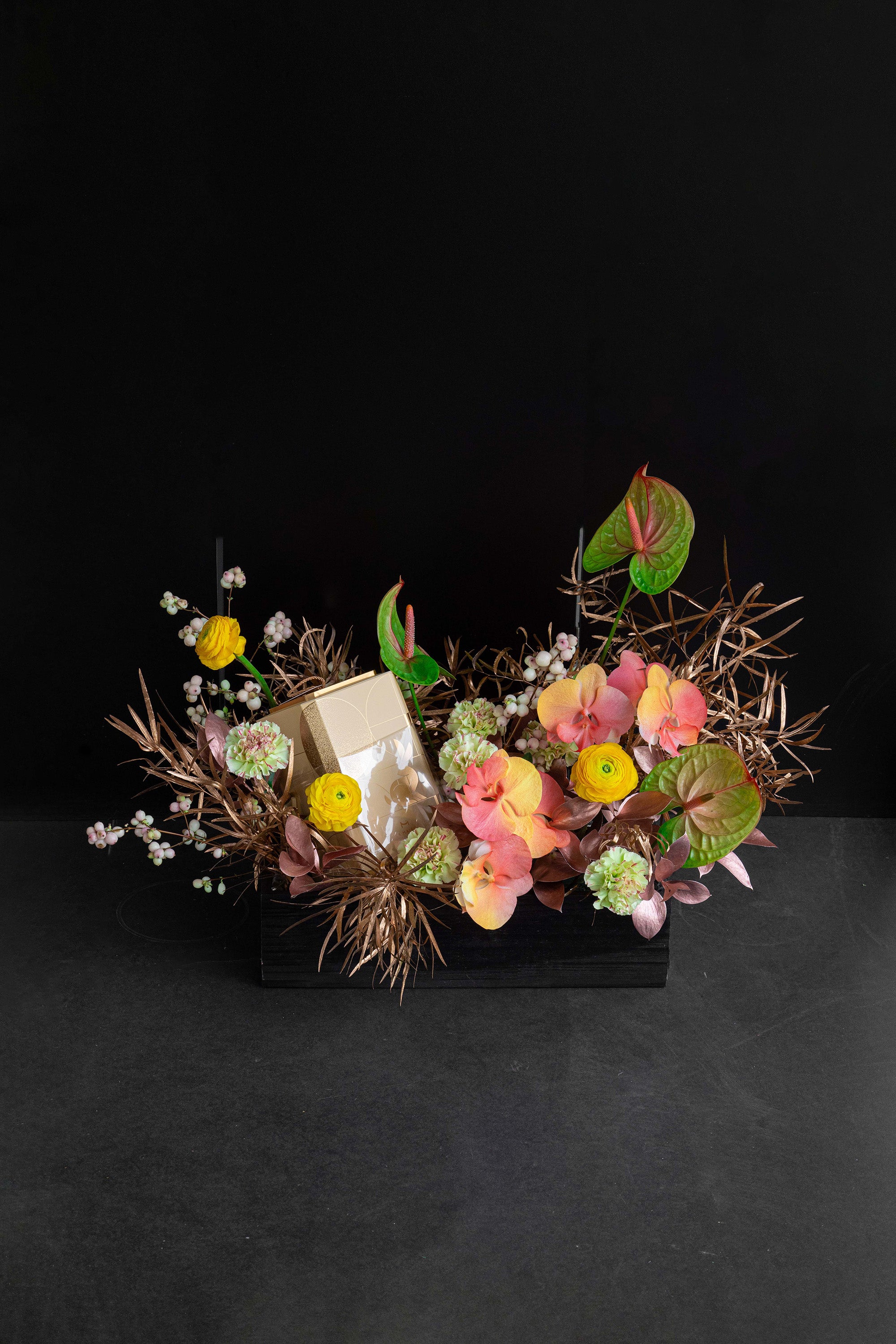Just Bloom Autumn Reflection flower box with golden yellow and coral florals against a black background — Just Bloom Hong Kong