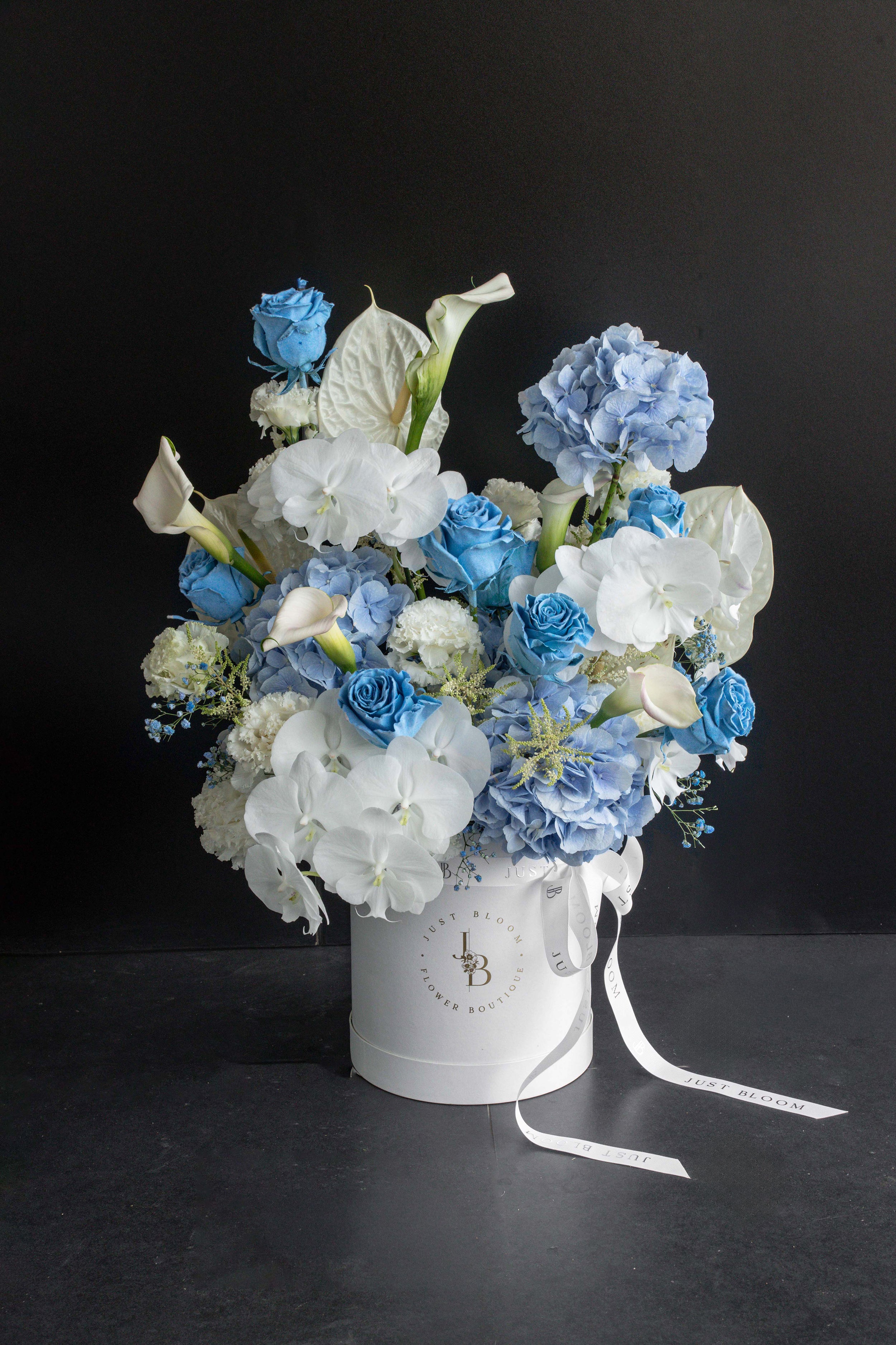 Blue Rhapsody flower box arrangement in a white Just Bloom box against a black backdrop — Just Bloom Hong Kong