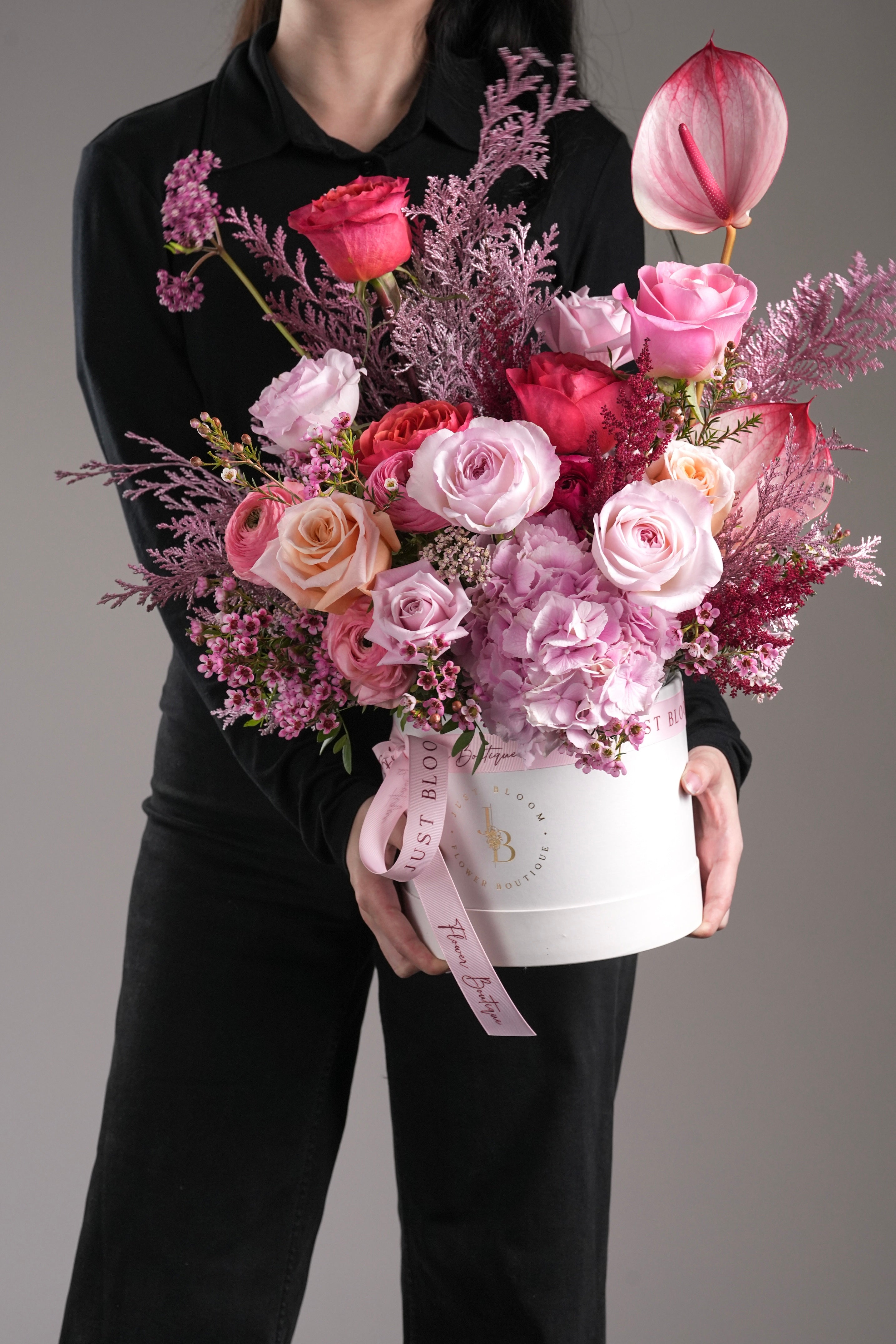 Model holding Coraline hatbox arrangement in front view