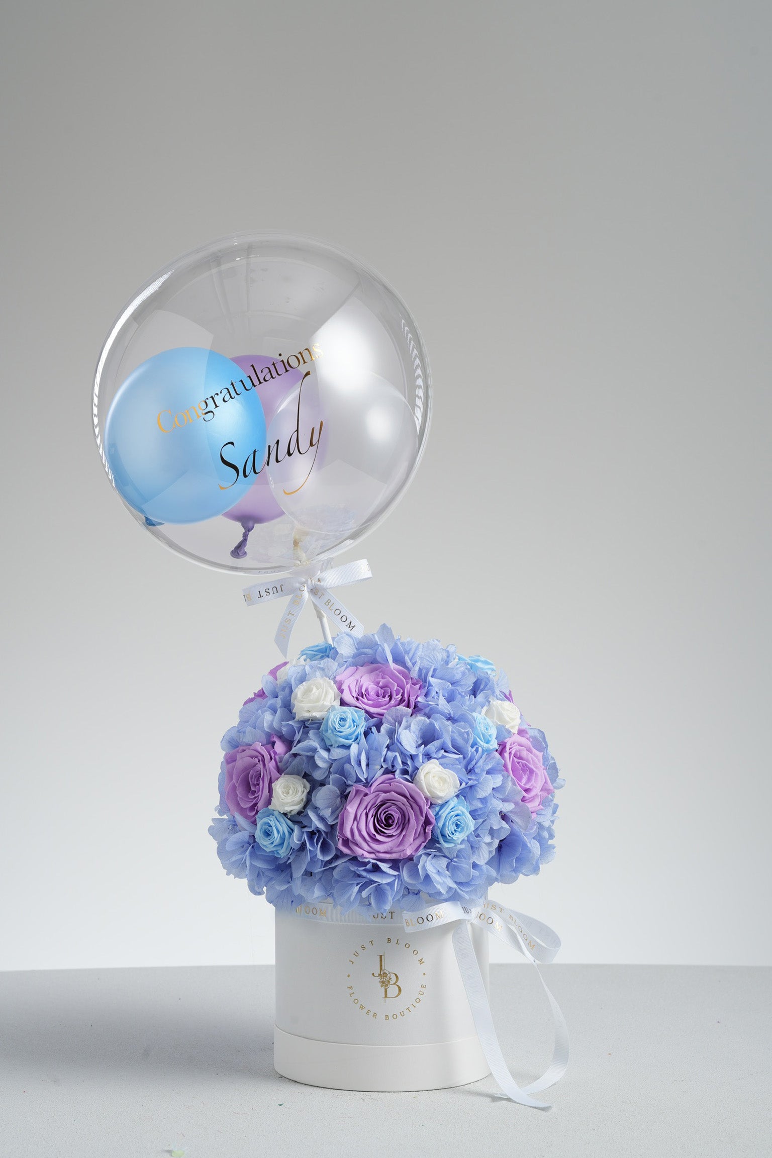 Eileen - A preserved flower box featuring blue hydrangeas, lavender, baby blue, and white roses in a soft colour palette. Elegant floral gift by Just Bloom HK