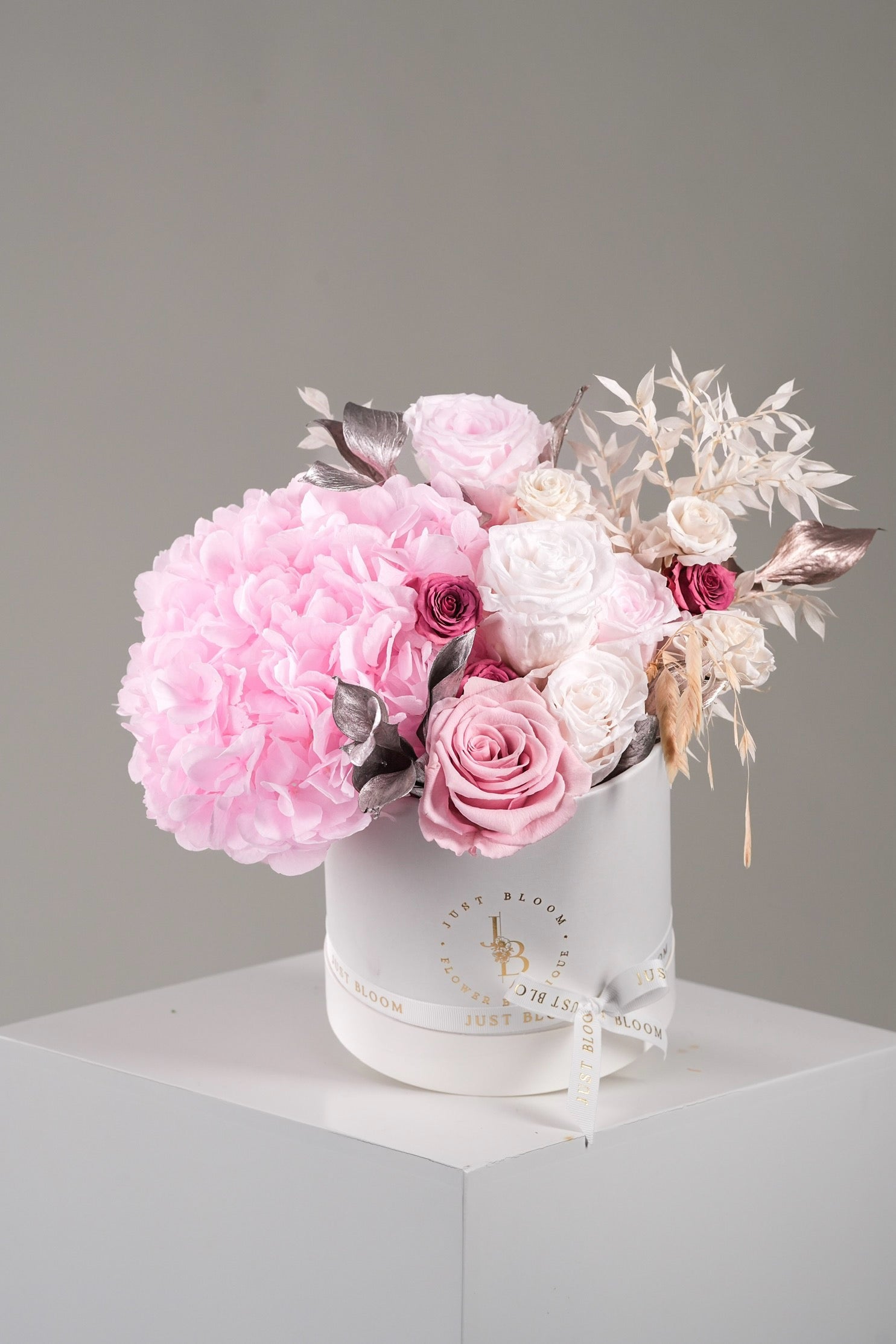 Elise preserved flower box with pink hydrangeas, roses, and metallic accents in round white hatbox
