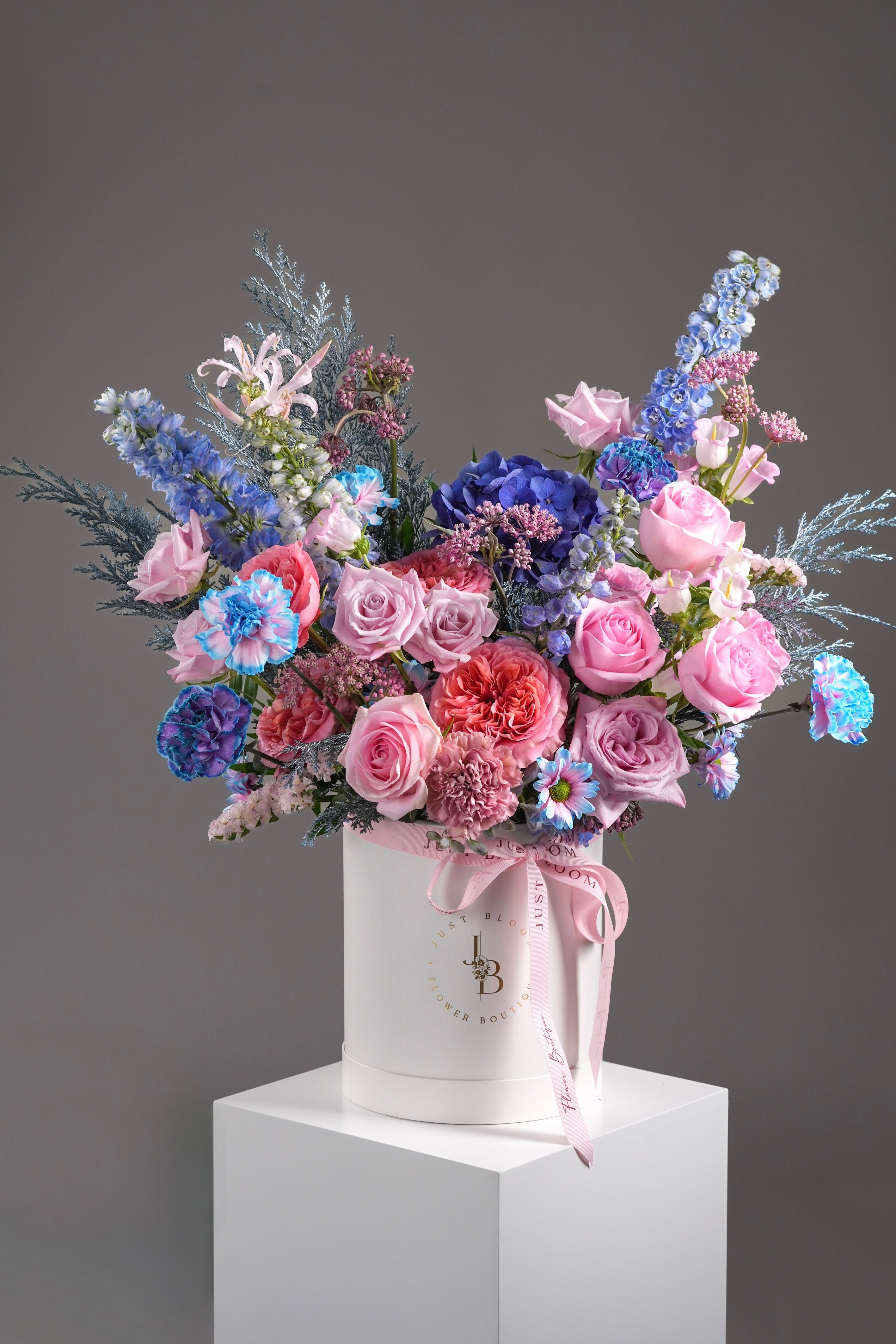 Main product image: Pink and blue floral hatbox arrangement with Ecuadorian roses and delphinium – Ella