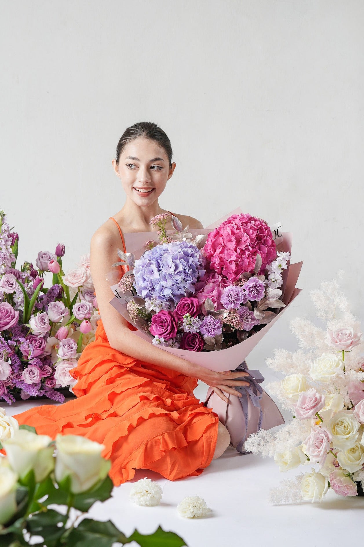 A luxurious bouquet with lavender roses, pink hydrangeas, and silver-toned foliage, wrapped in elegant style.