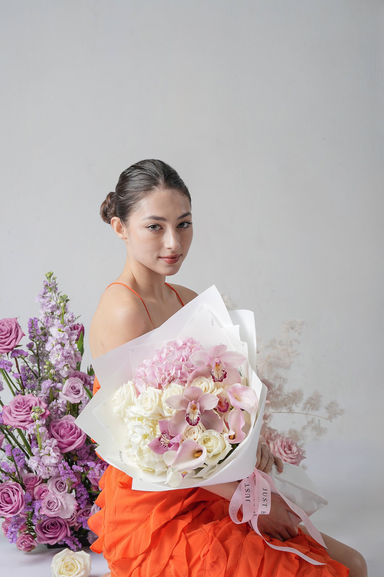 Gentle Years - A white and blush bouquet featuring cymbidium orchids, roses, hydrangeas, and calla lilies. A serene and elegant floral gift for Mother’s Day 2025 by Just Bloom Hong Kong.