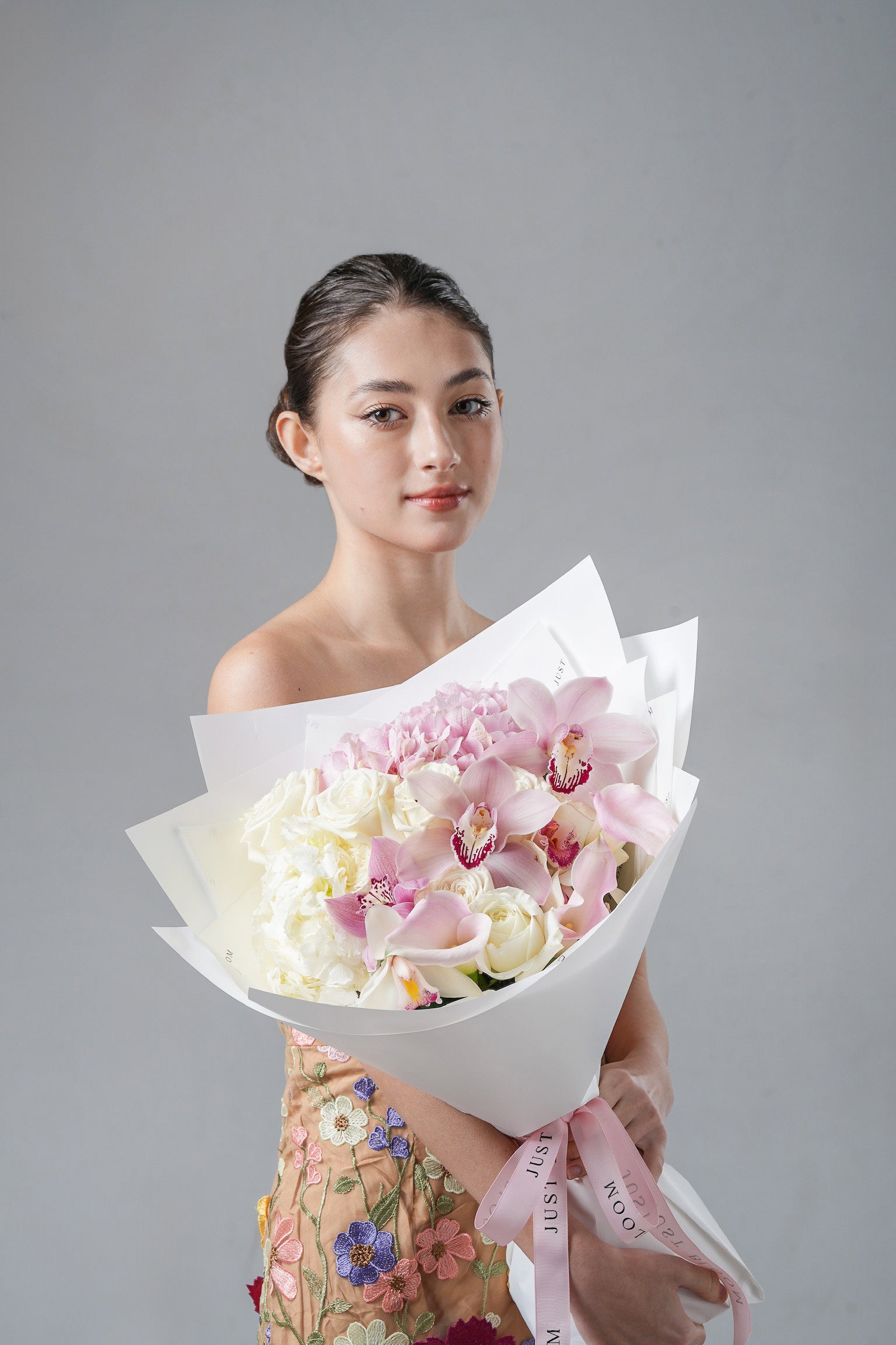 Gentle Years - A white and blush bouquet featuring cymbidium orchids, roses, hydrangeas, and calla lilies. A serene and elegant floral gift for Mother’s Day 2025 by Just Bloom Hong Kong.