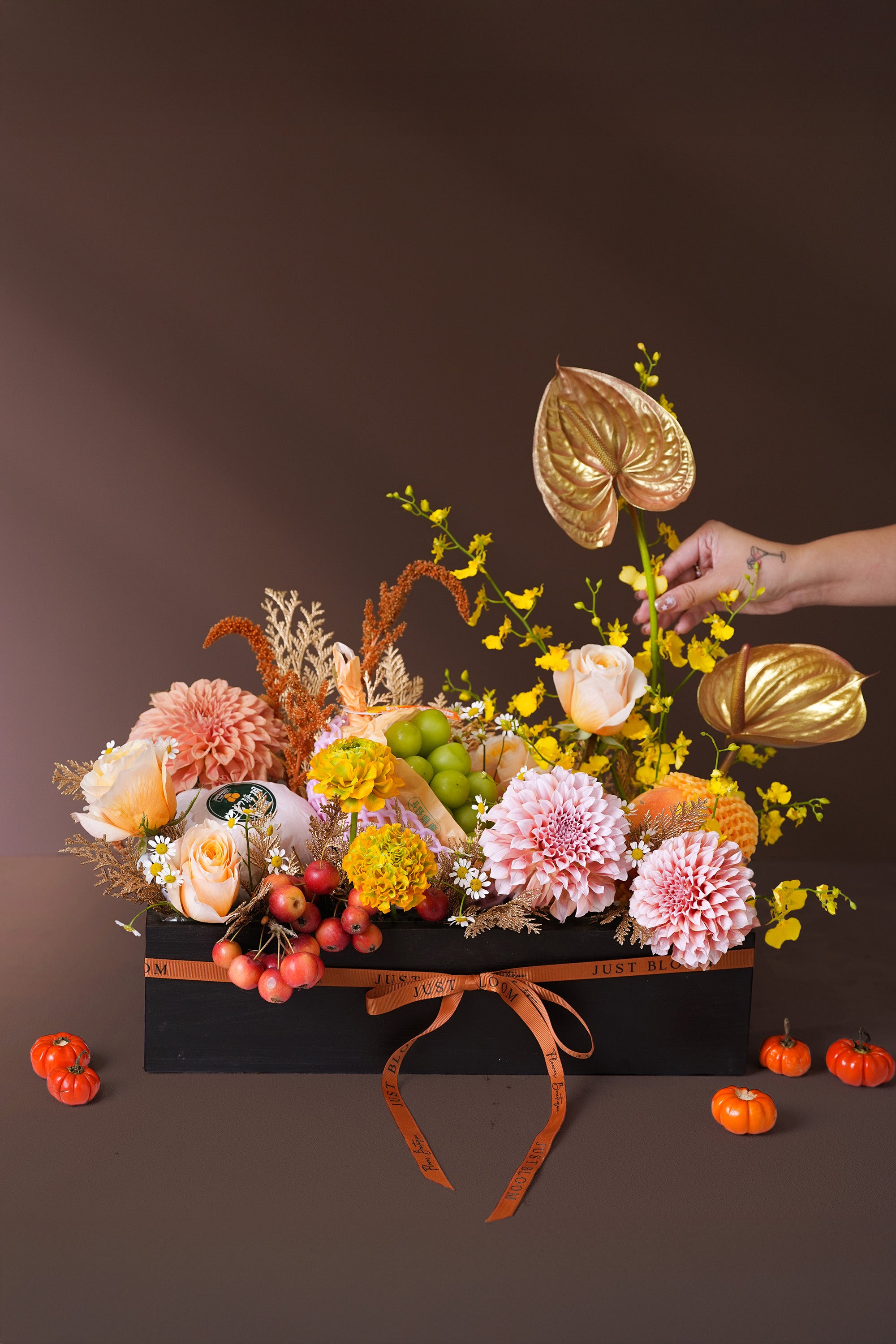 Golden Harvest Mid-Autumn edition in black gift box with dahlias, golden anthuriums, and festive fruits styled with orange ribbon