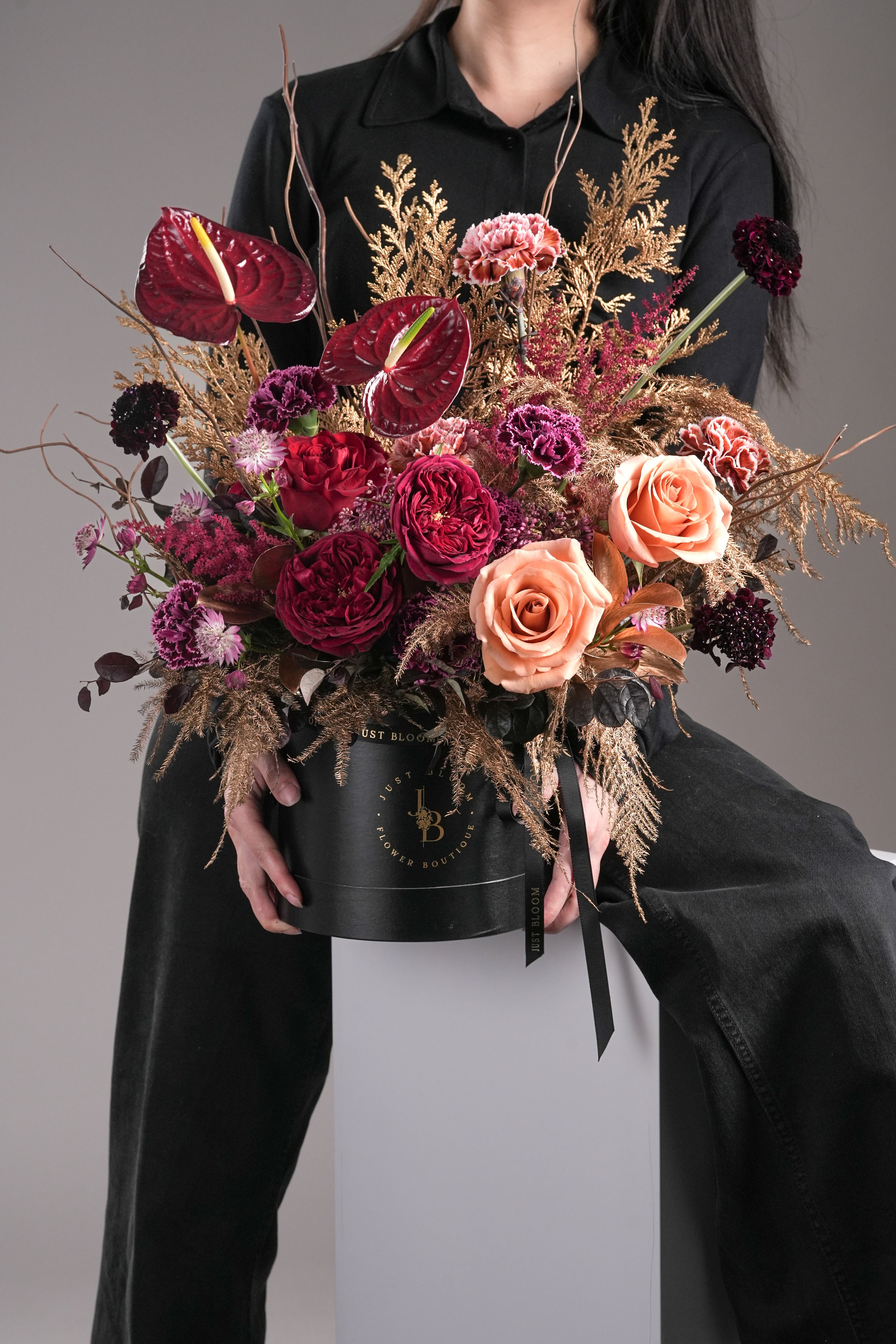Woman holding Griselda luxury preserved flower box with red and peach roses – Just Bloom Hong Kong