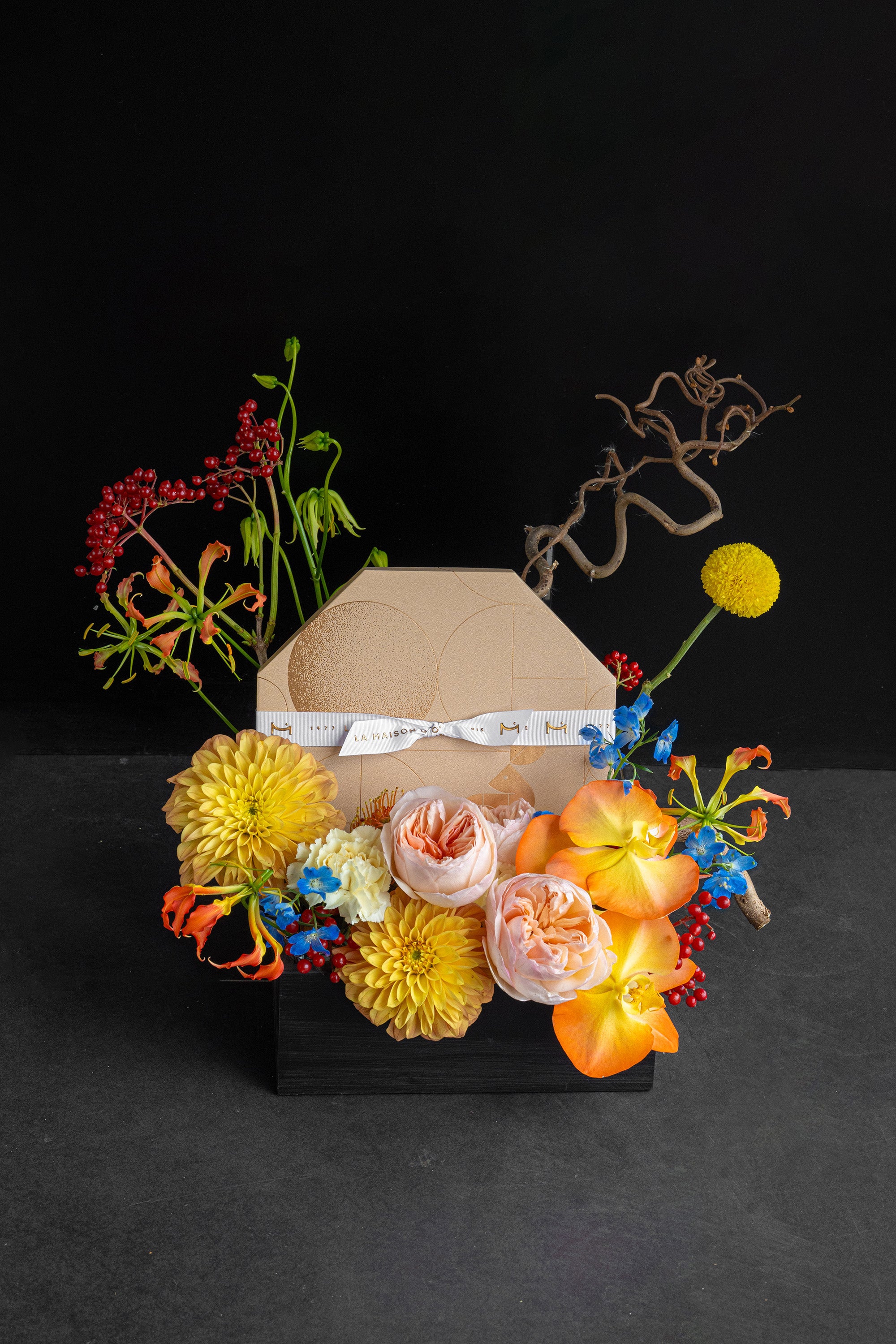 Just Bloom Autumn Reflection flower box with golden yellow and coral florals against a black background — Just Bloom Hong Kong