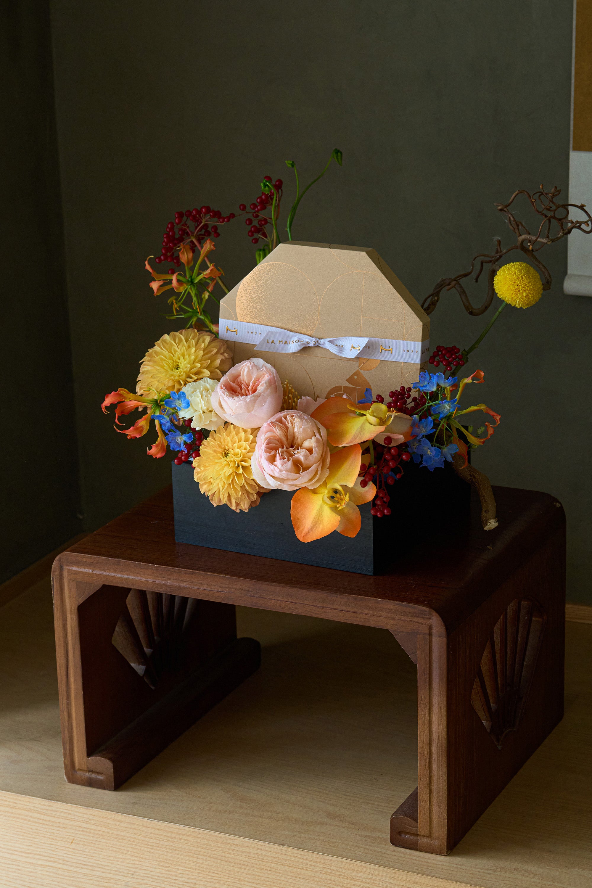 Just Bloom Harvest Gathering flower box with peach and yellow florals and chocolate gift box displayed on a wooden stand — Just Bloom Hong Kong