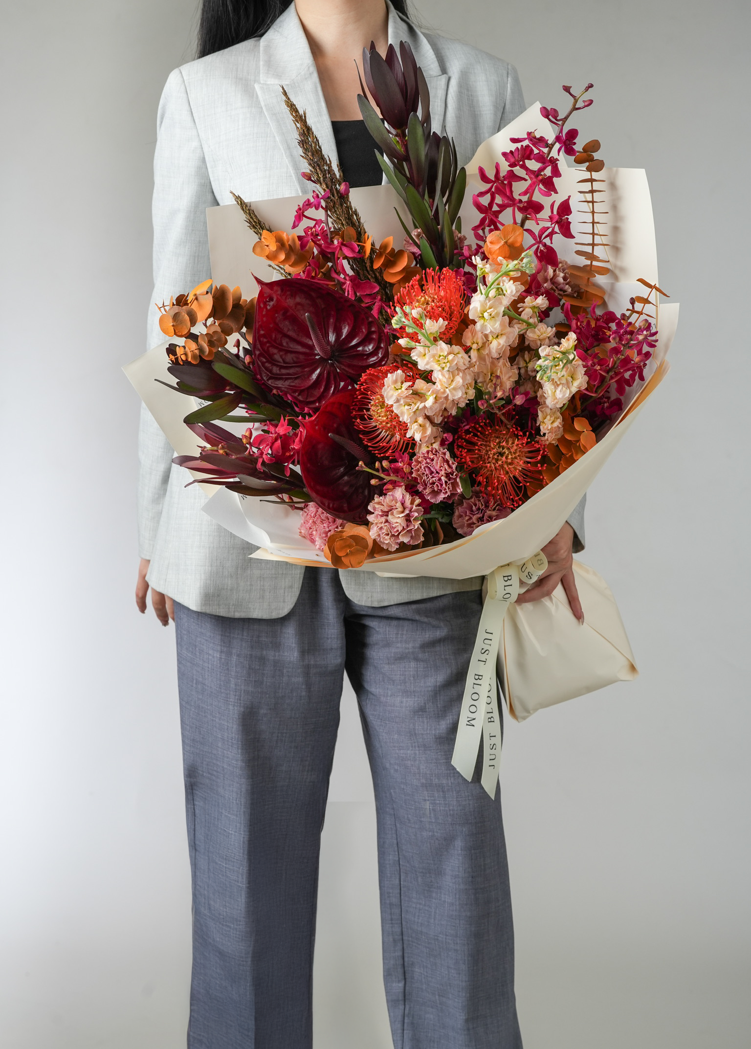 Inferno luxury bouquet featuring anthuriums, pincushion proteas, carnations and stocks in a bold contemporary design by Just Bloom Hong Kong