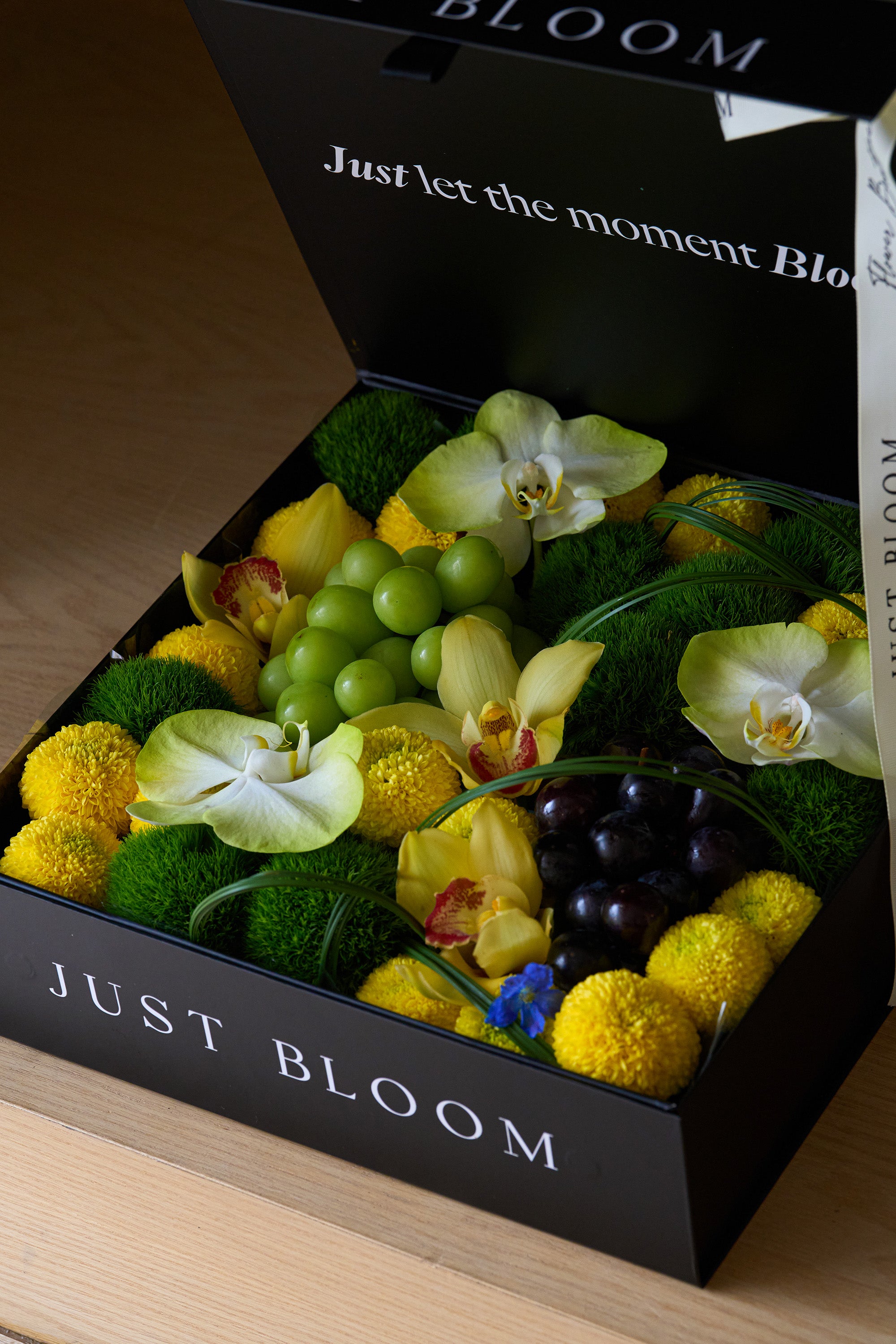 Close-up of Jade Moon flower box arrangement with green and black grapes — Just Bloom Hong Kong