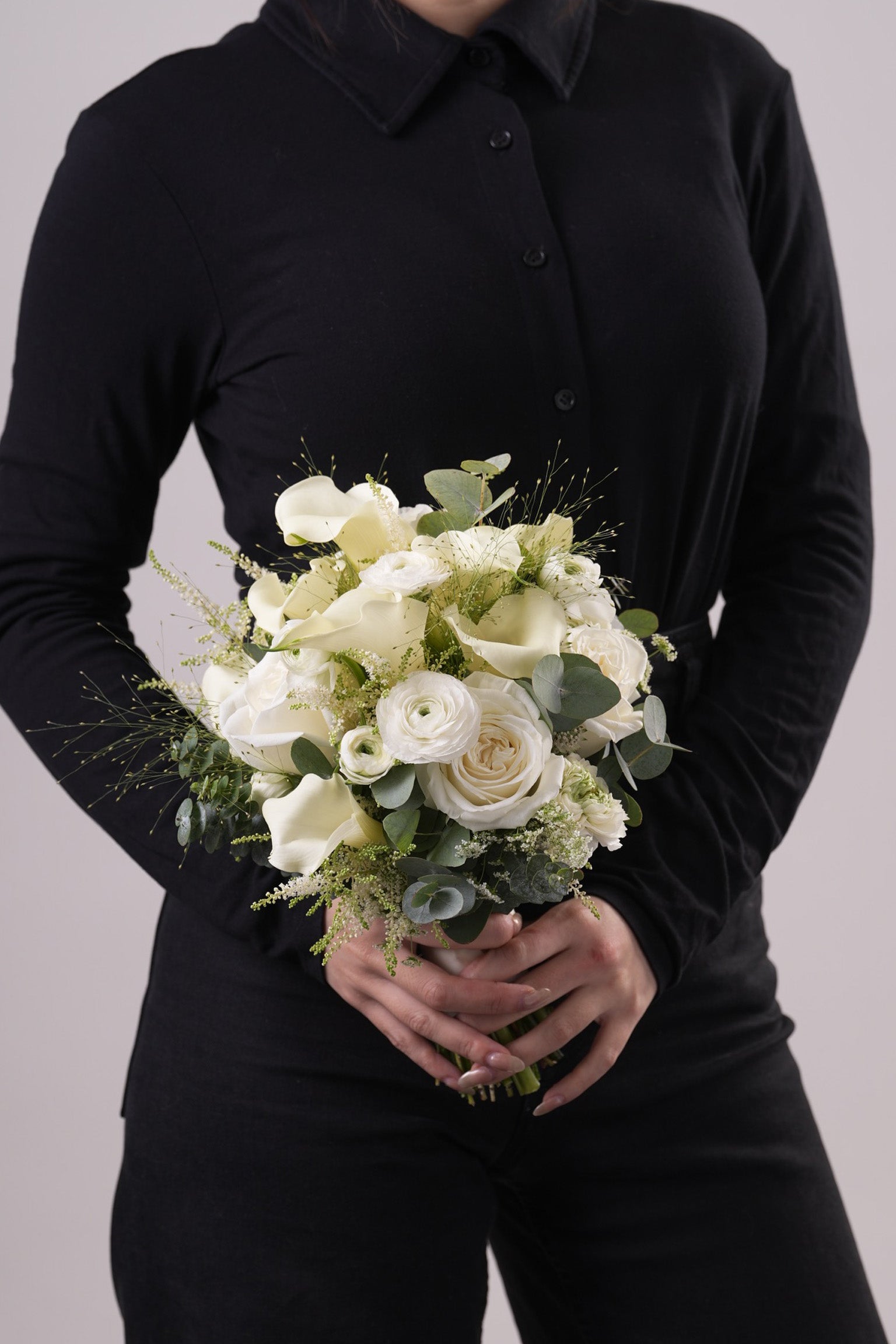 Side angle of Anne wedding bouquet showcasing soft white florals and eucalyptus