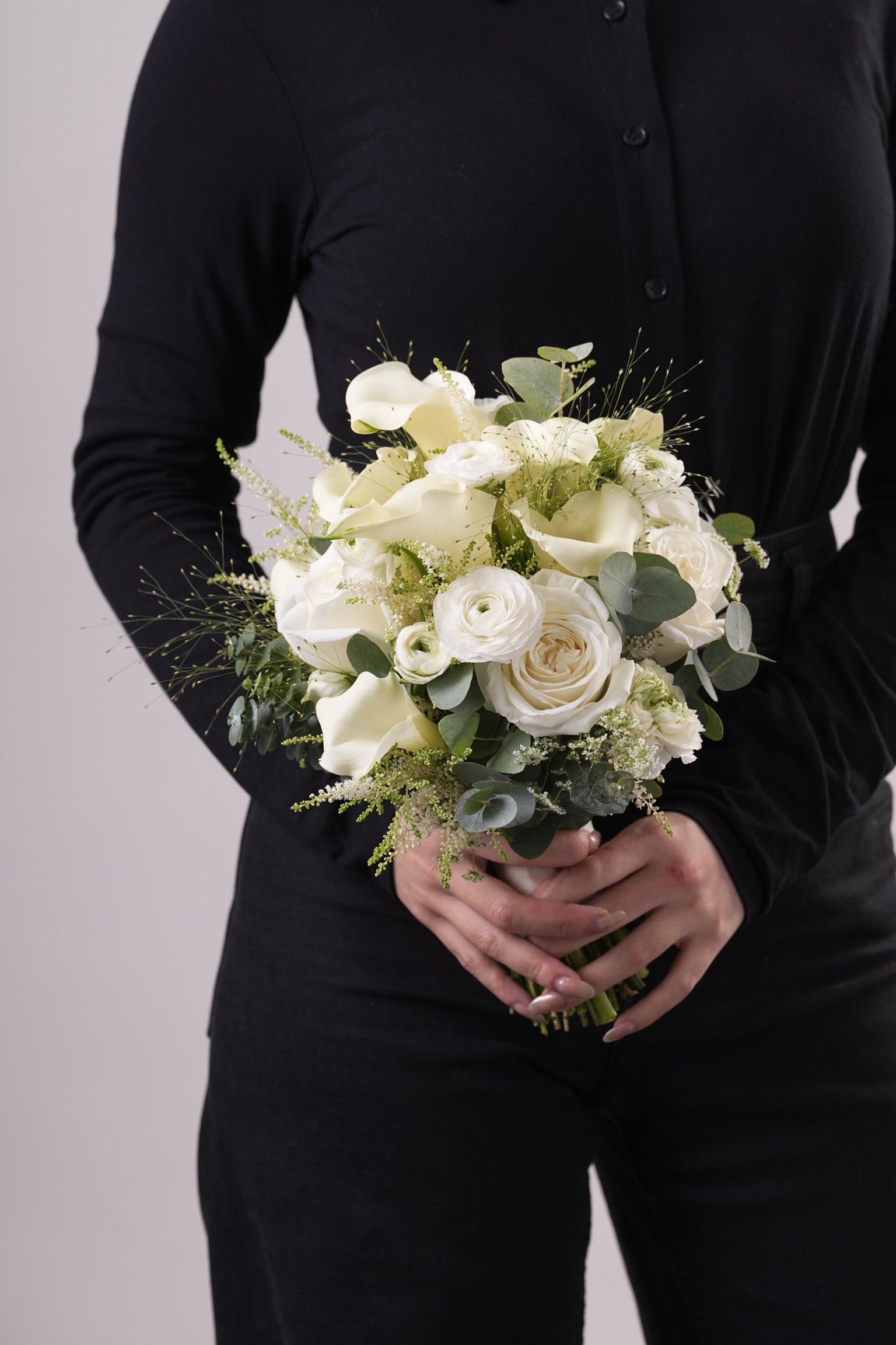Top view of Anne bridal bouquet highlighting layers of creamy roses and fine foliage