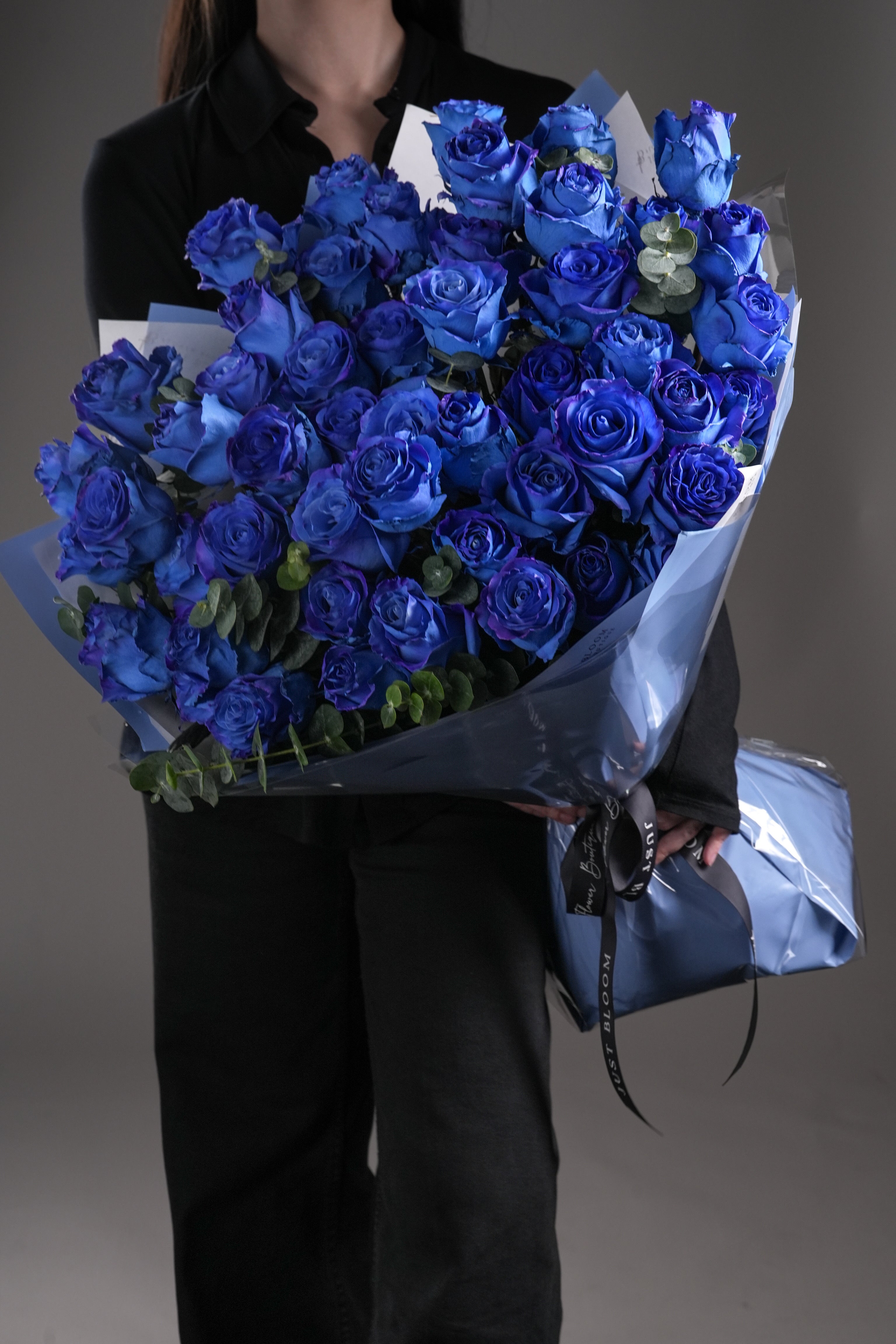 Close-up view of premium blue rose petals in Eva bouquet, wrapped with luxury finish