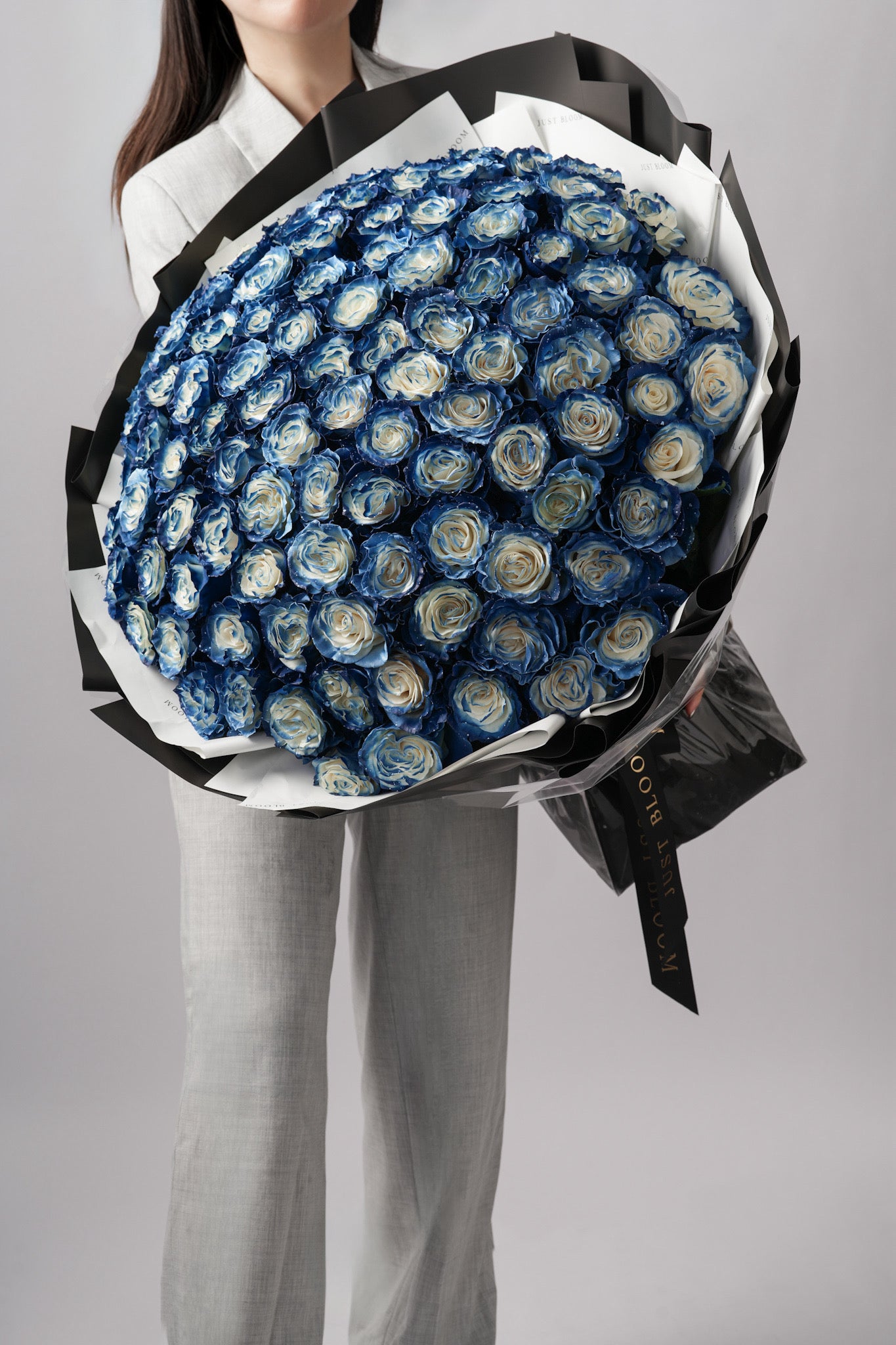 Model holding large ombré blue and ivory rose bouquet from Just Bloom Hong Kong