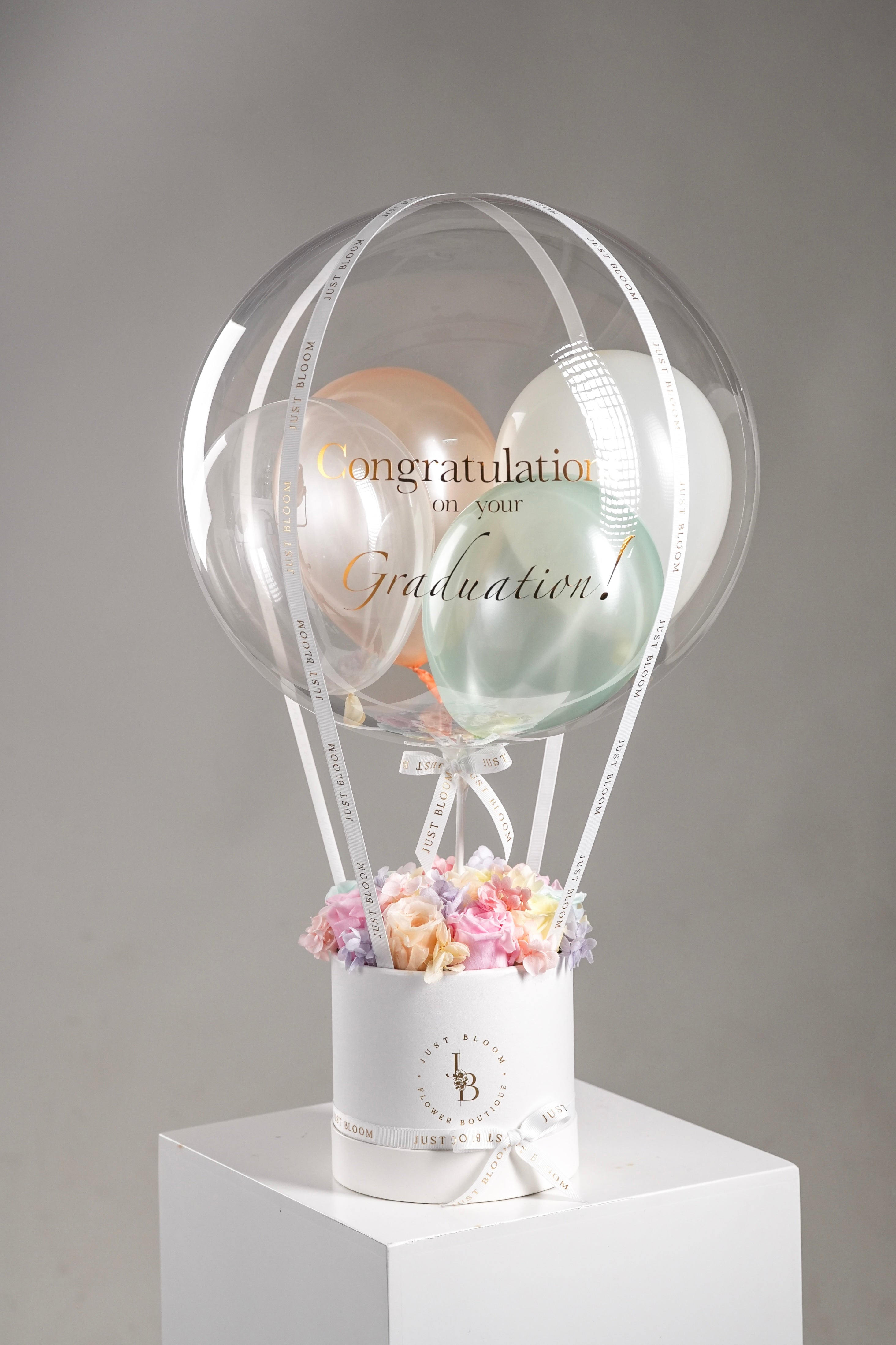 Kayla multi-color preserved flower box in white round container on display