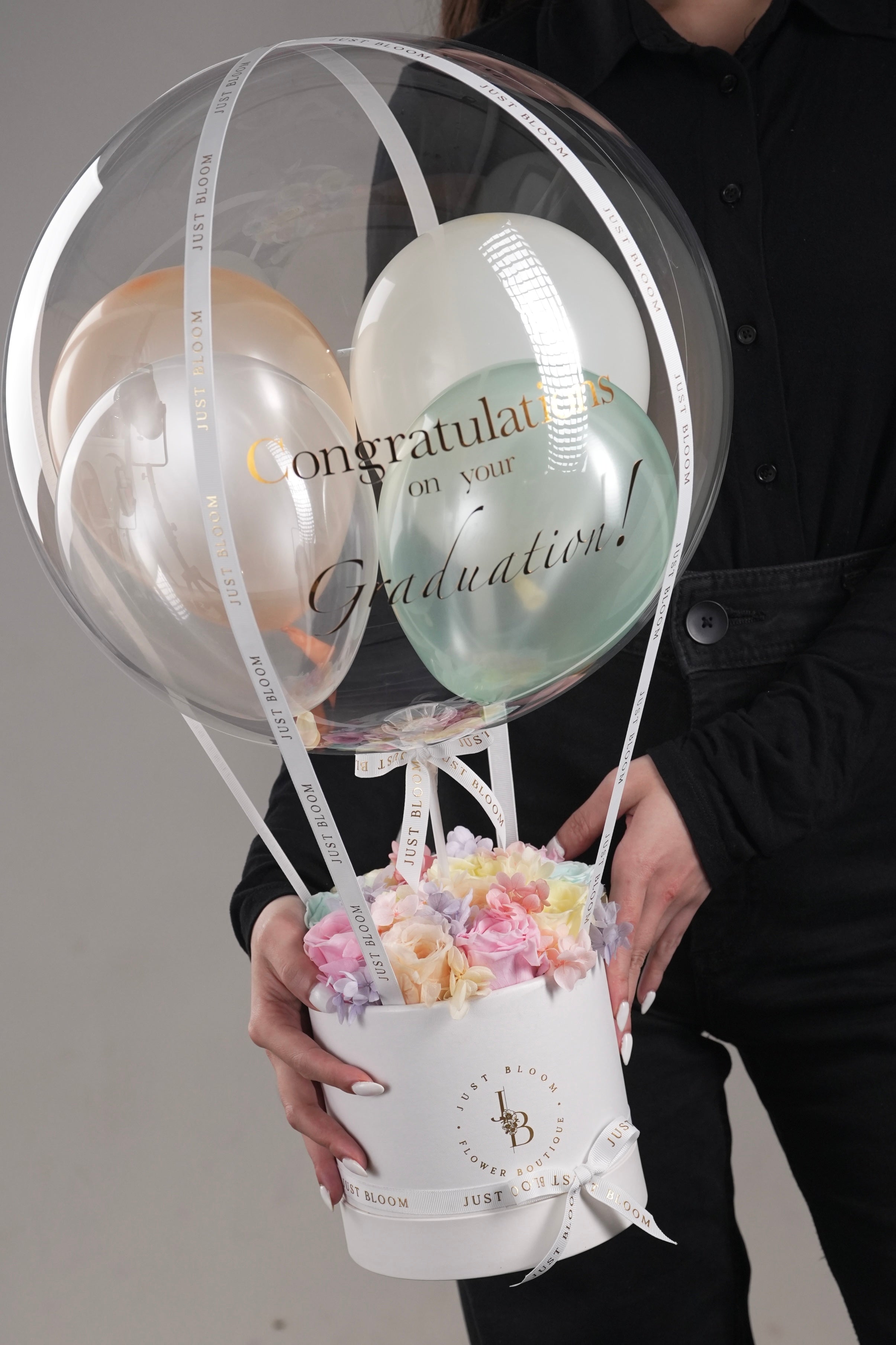 Woman holding Kayla preserved flower arrangement showing scale and design details
