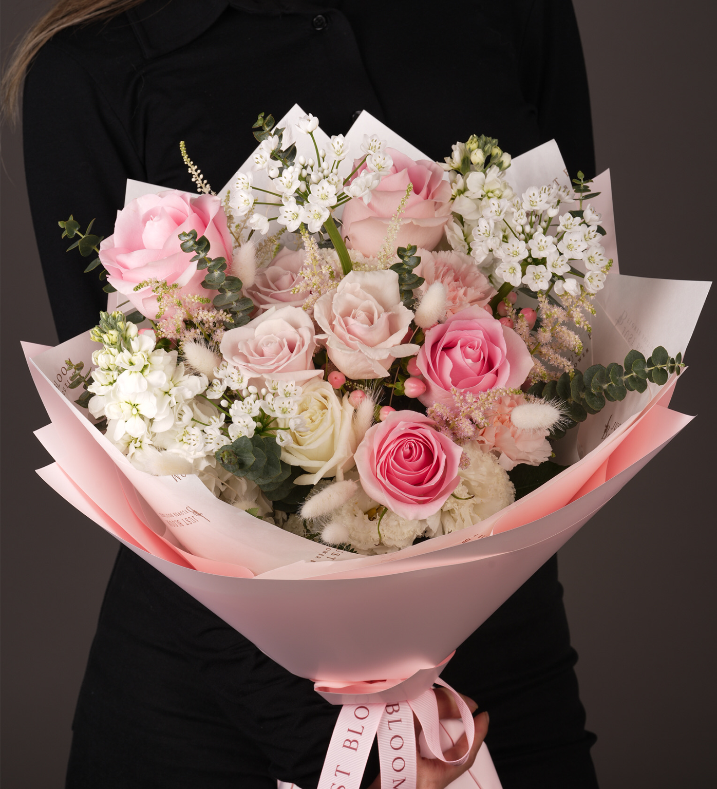 Close-up view of Kennedi bouquet showing pink roses, white flowers, and textural Dutch filler flowers