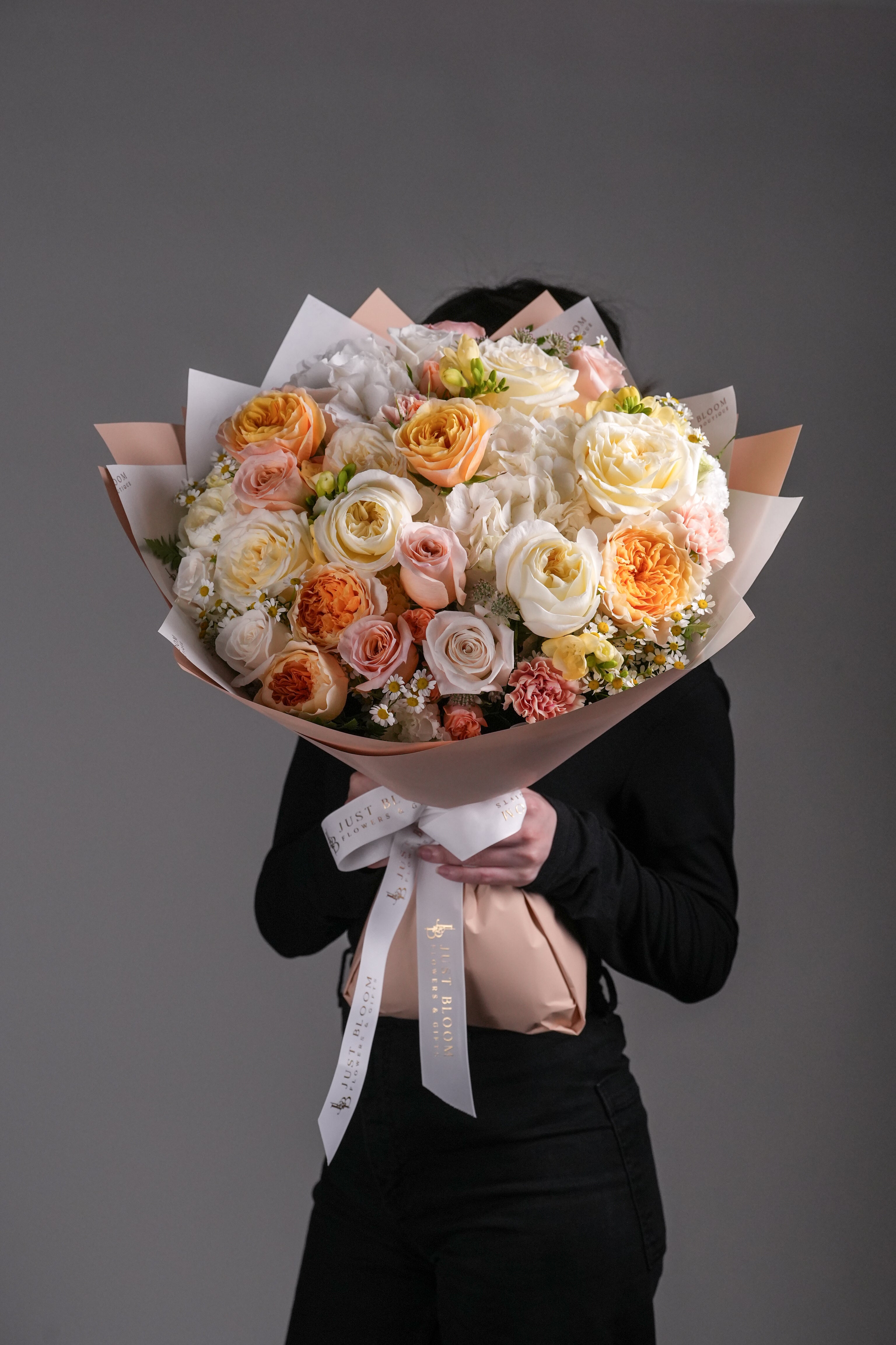 Close-up view of Khloe bouquet showing garden roses, hydrangeas, and mixed delicate flowers