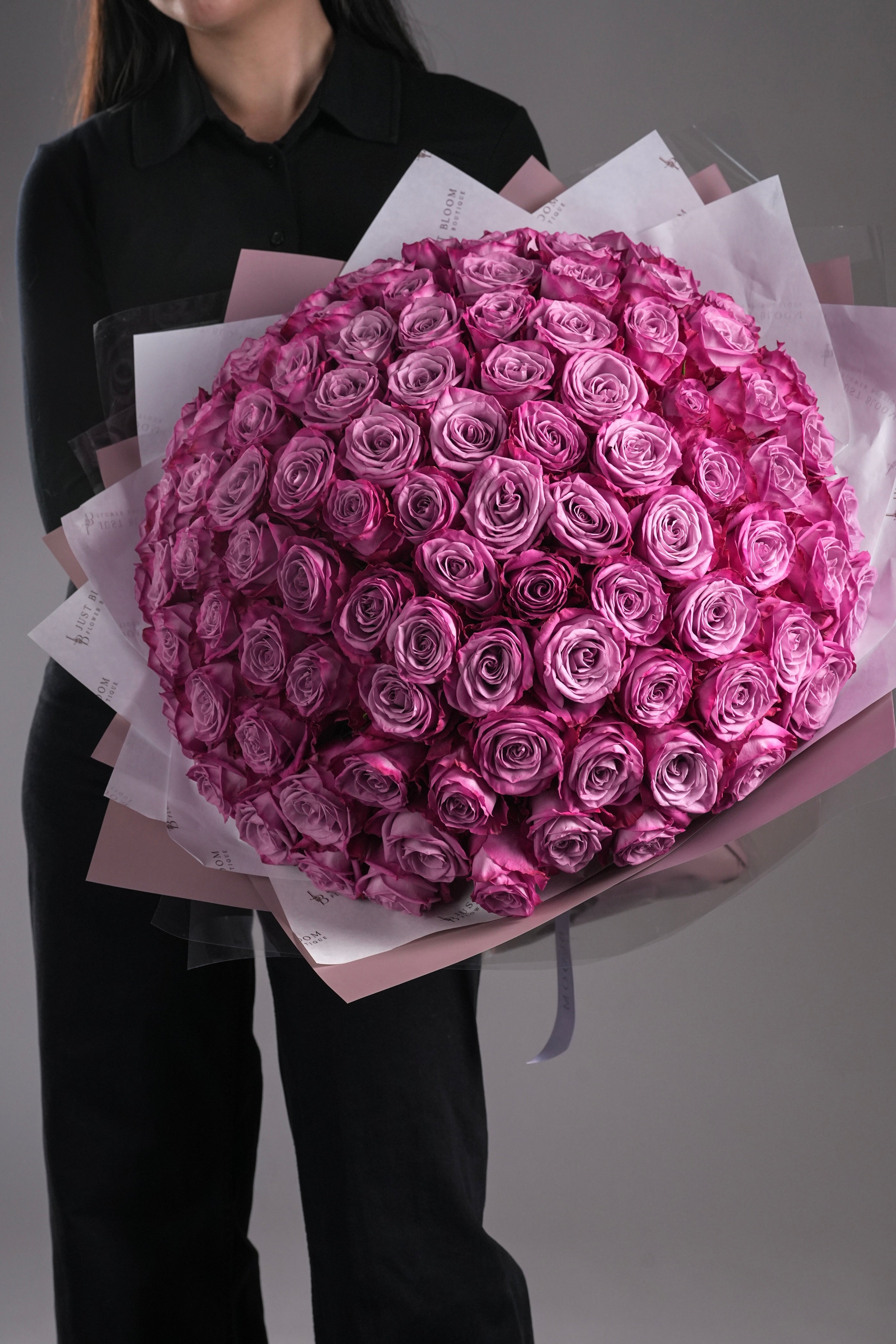 Close-up view of Kinley purple rose bouquet showing gradient purple tones and dome arrangement