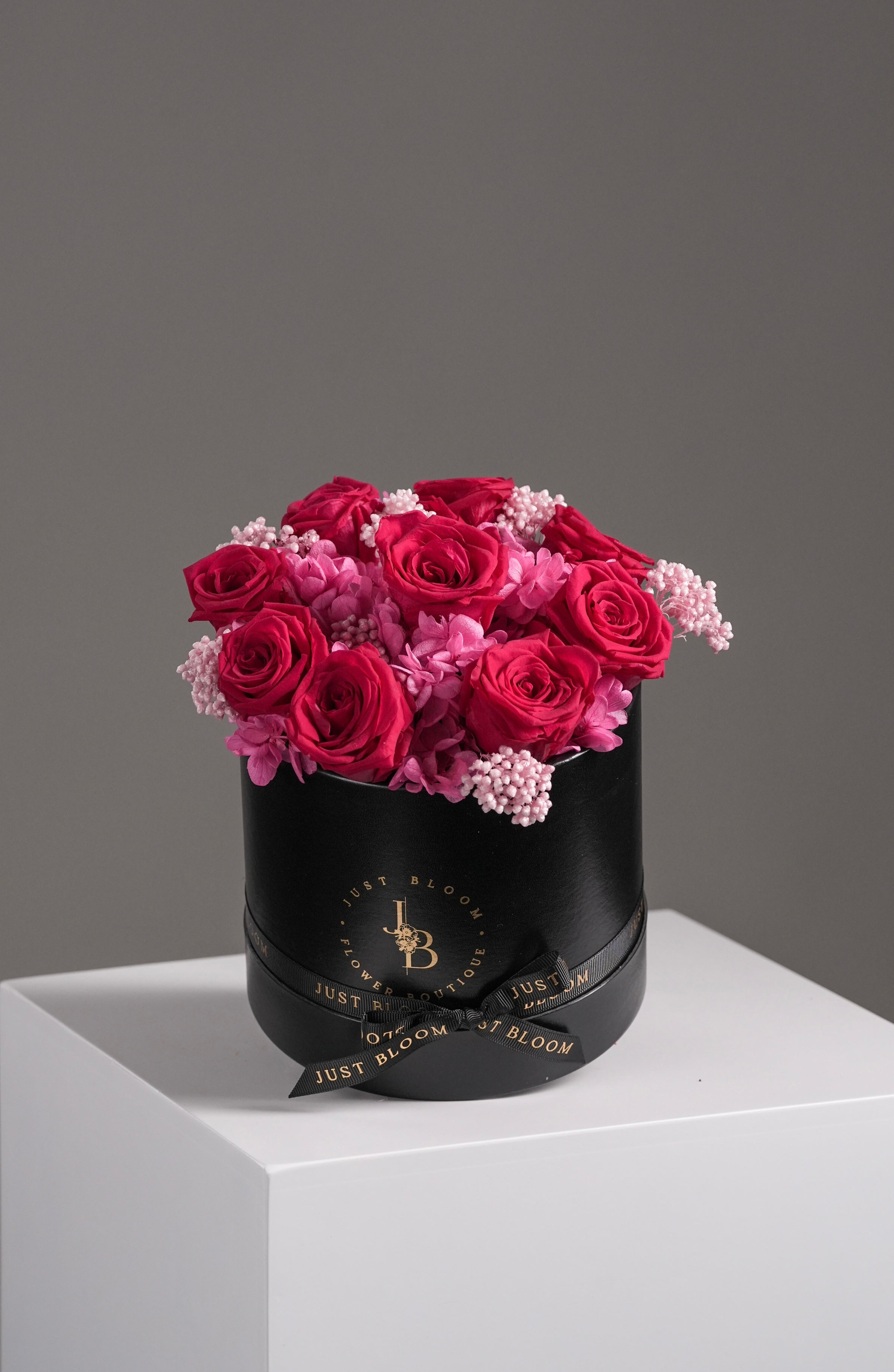 Leah red preserved rose flower box with pink hydrangeas in black round hatbox with gold branding