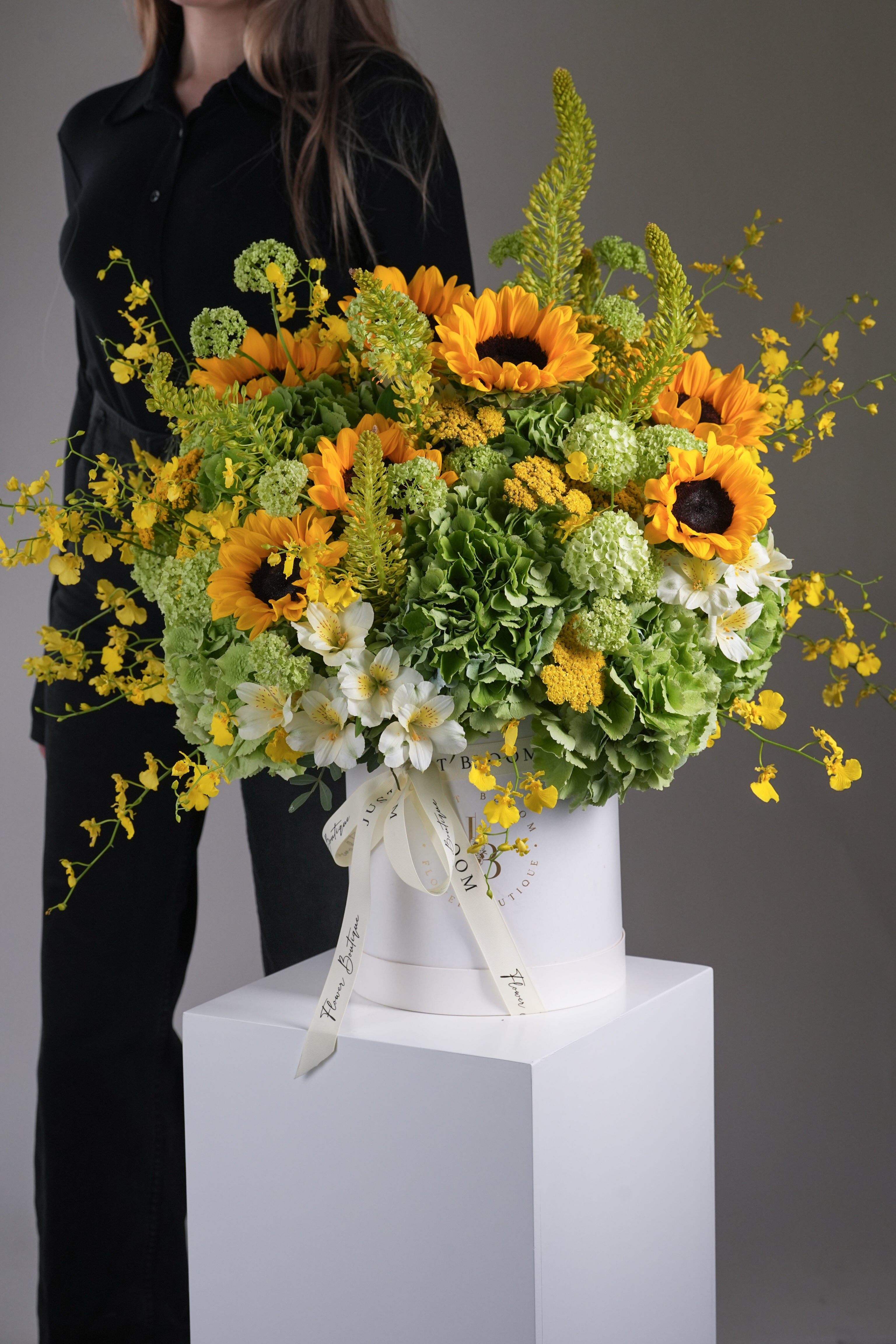 Leo sunflower and orchid flower box – shown with model for size reference | Just Bloom HK