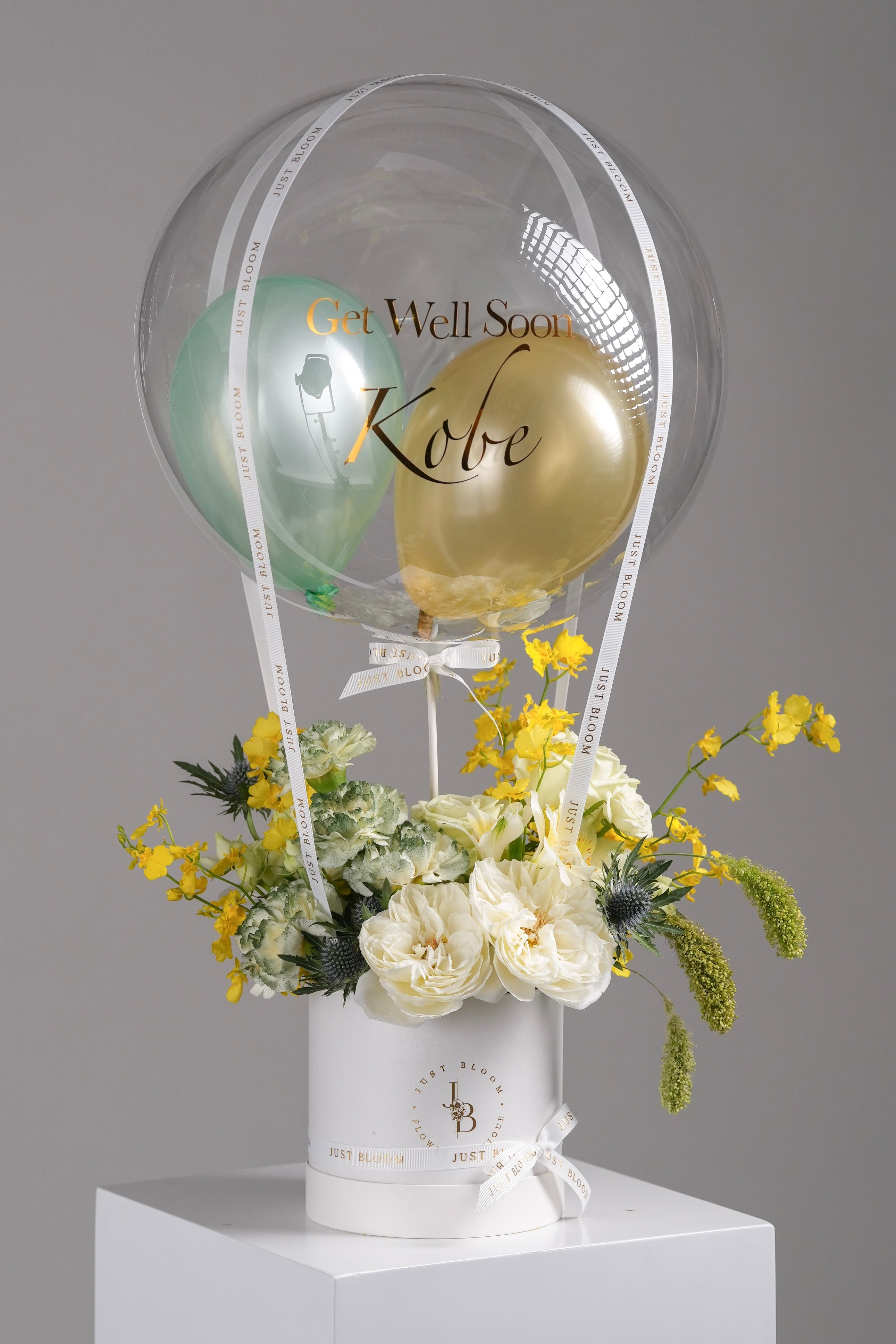Linnea white garden rose and orchid balloon flower box featuring white roses and yellow fillers