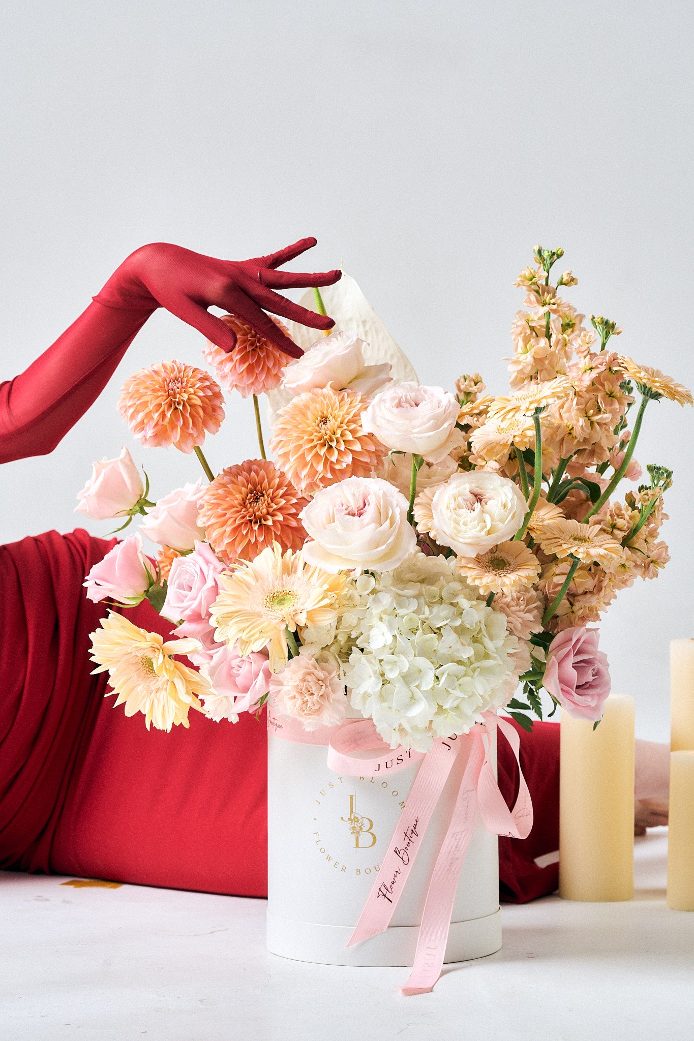 Hand reaching for Love at First Sight flower box showing scale and romantic arrangement details