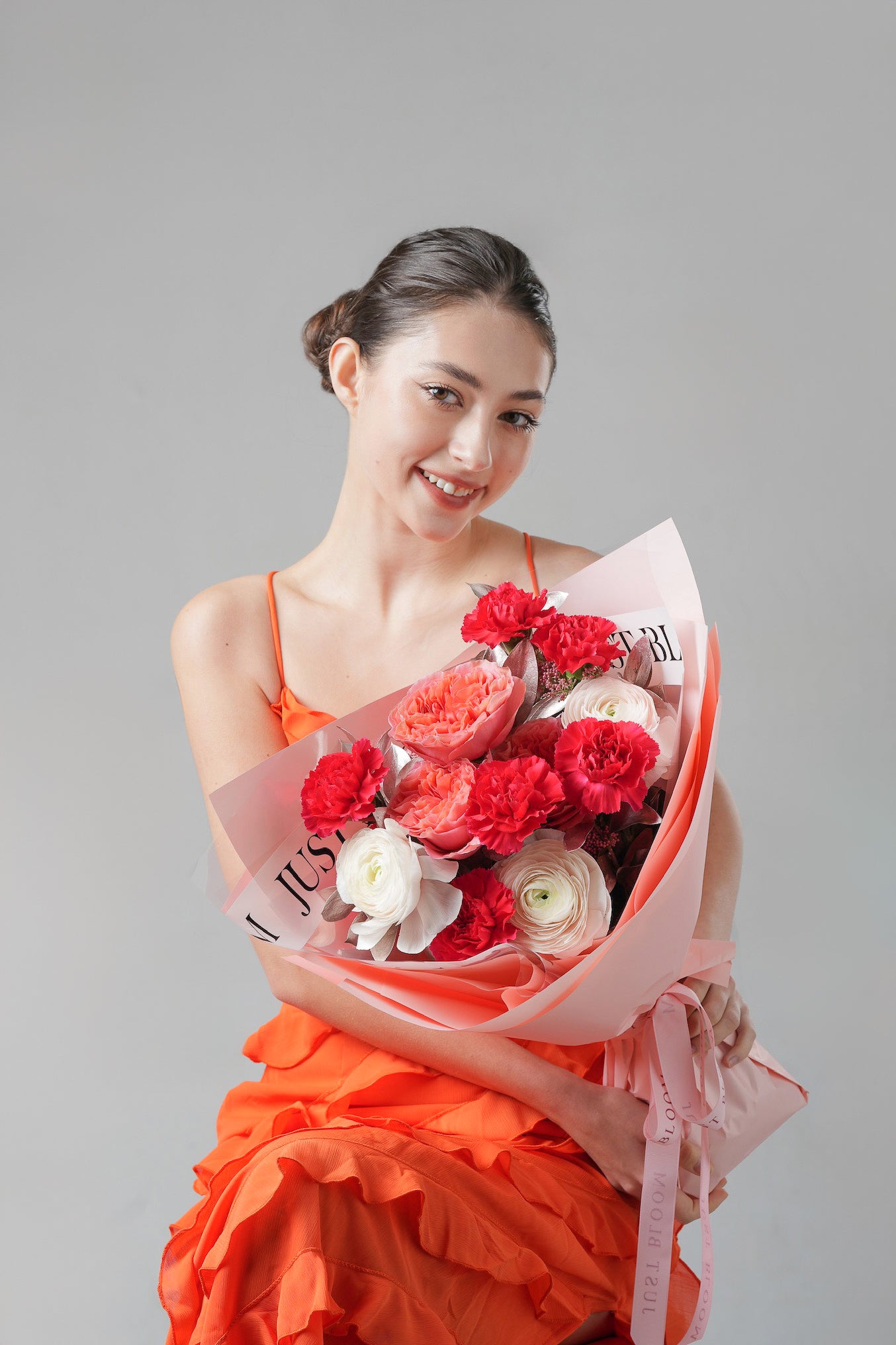Loved Hours - A vibrant Mother’s Day bouquet featuring red carnations, peach roses, and white ranunculus. A joyful floral tribute to the cherished moments of motherhood. Available for same-day delivery in Hong Kong by Just Bloom.