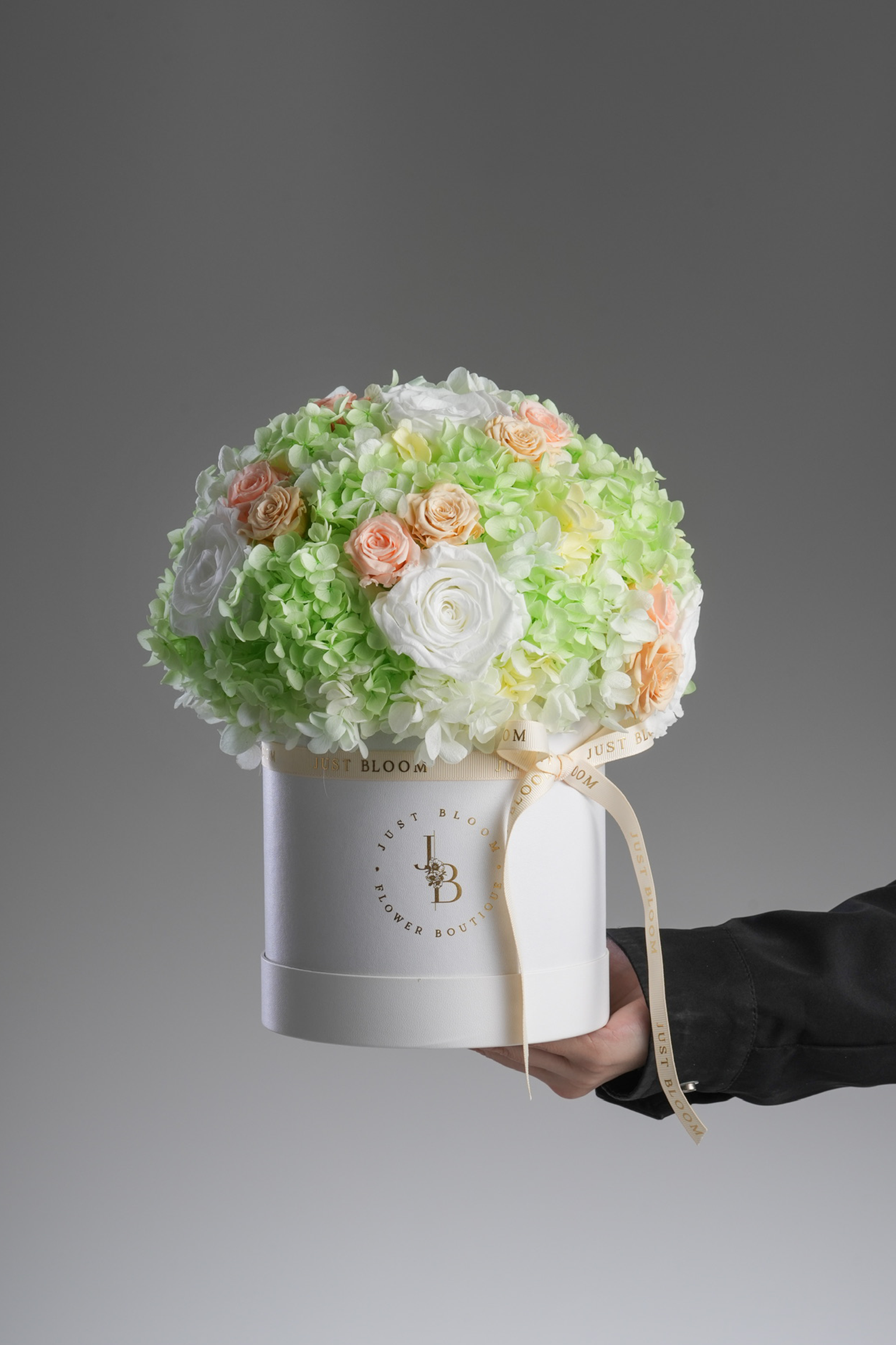 Mara - A preserved flower box with ivory roses, pastel green hydrangeas, and peach accents. A refreshing and elegant floral gift by Just Bloom HK