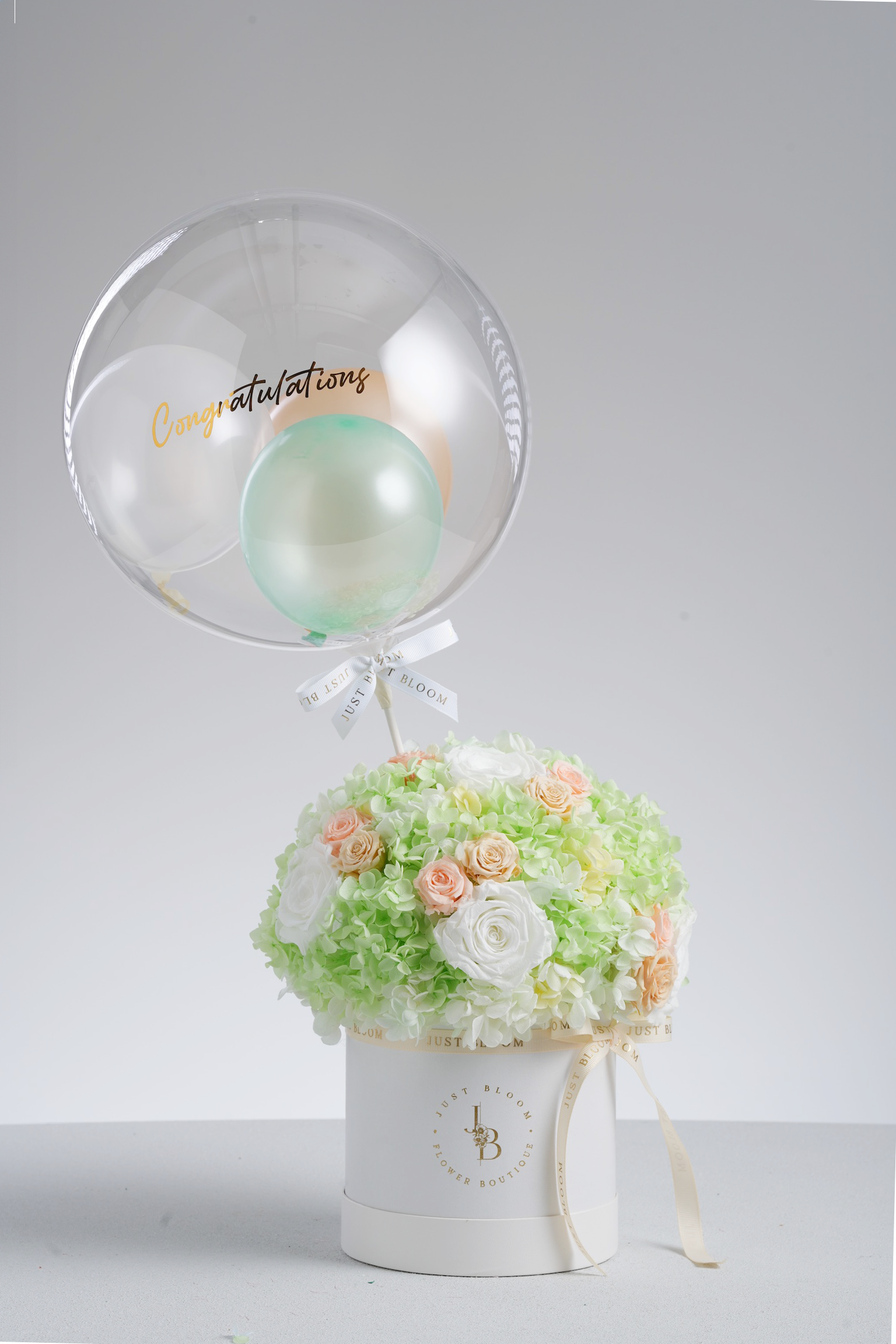 Mara - A preserved flower box with ivory roses, pastel green hydrangeas, and peach accents. A refreshing and elegant floral gift by Just Bloom HK