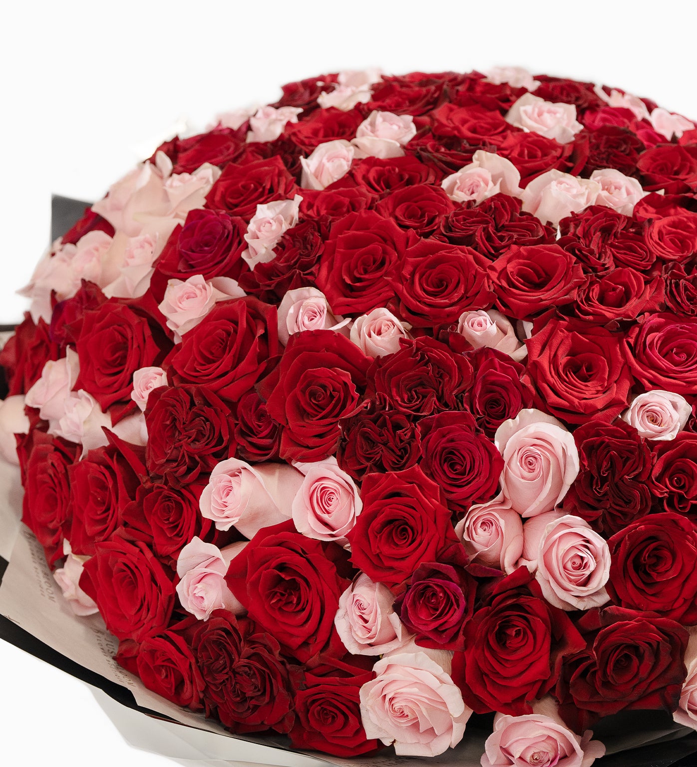 Close-up of Marisol bouquet showing lush red and pink Ecuadorian roses