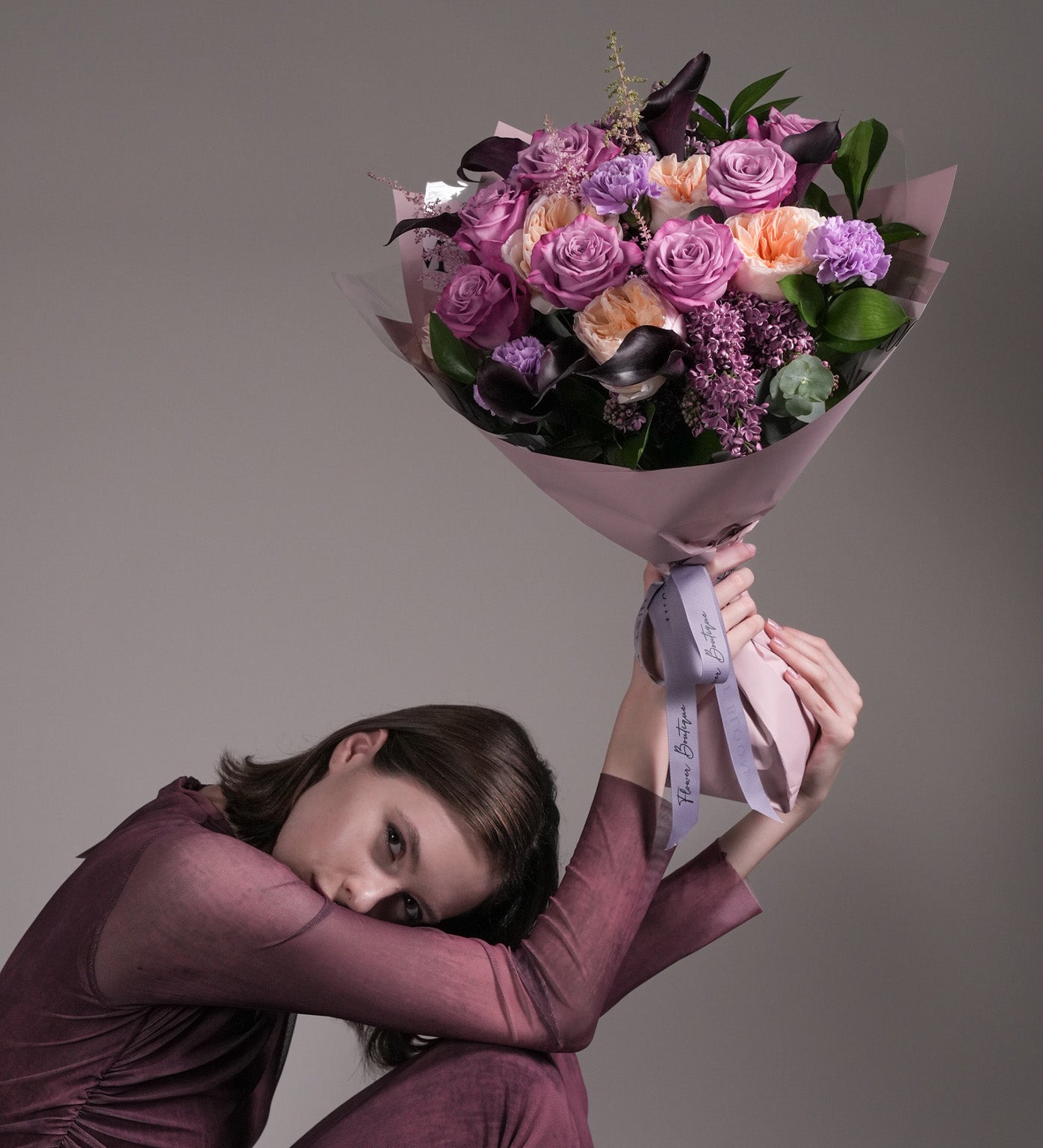 Maternal Grace bouquet in purple and lavender with roses, Juliet garden roses, carnations, and astilbes