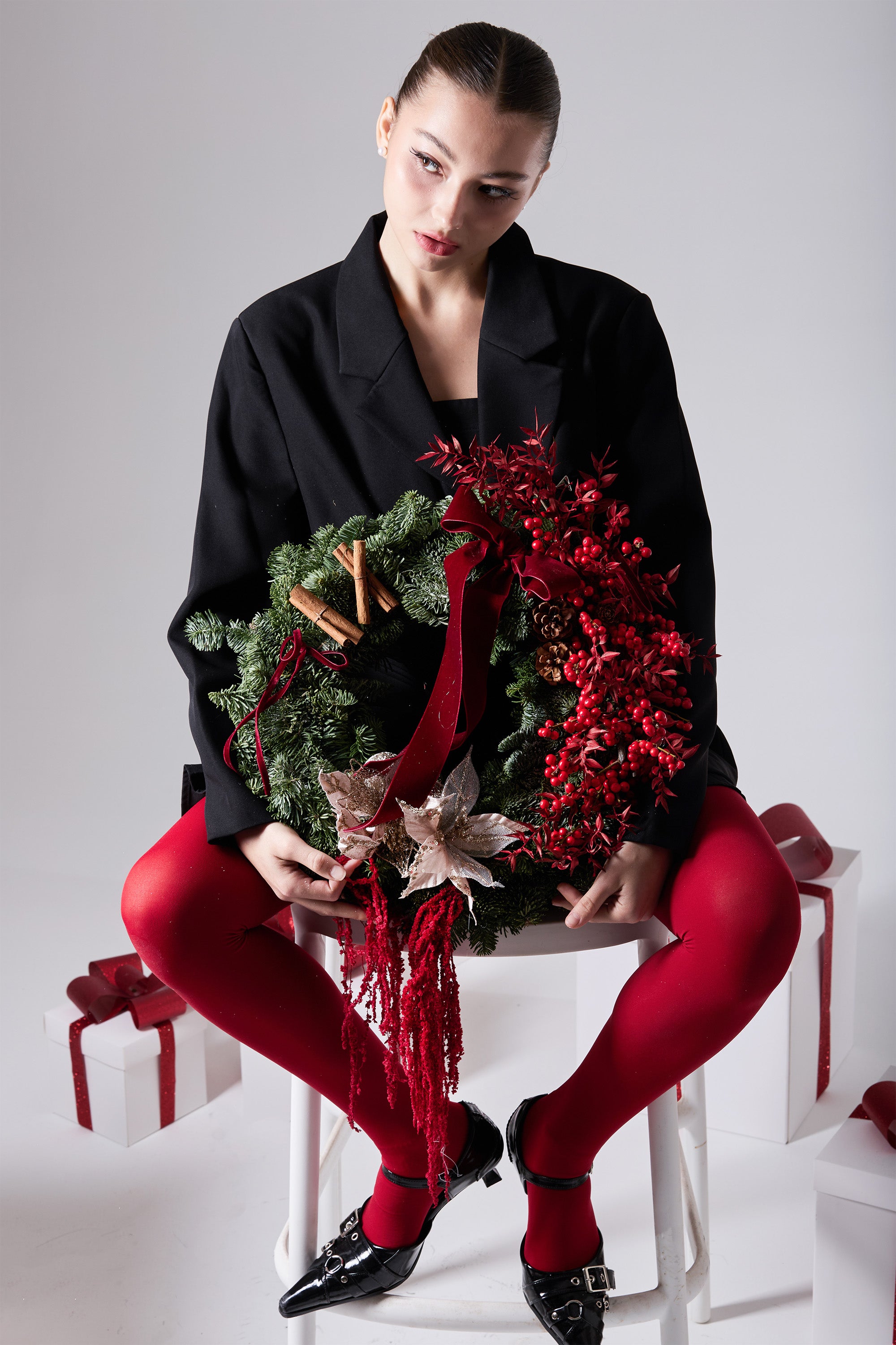 Merlot Solstice winter wreath with wine-red ornaments and evergreen foliage