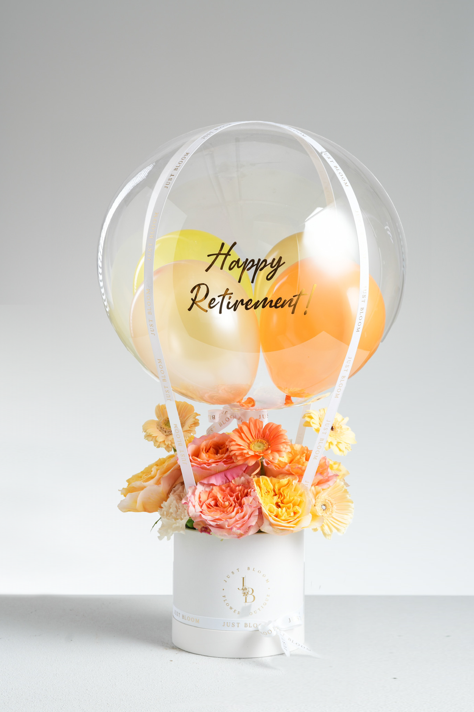 Michaela peach and yellow flower arrangement gift box with crystal balloon, roses, gerberas, and carnations