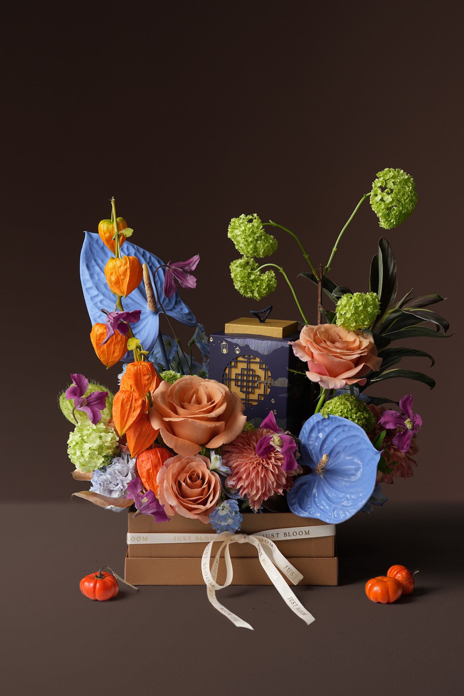 Midnight Lantern Mid-Autumn gift box with orange roses, blue anthuriums, lantern fruit, and La Maison du Chocolat mooncakes