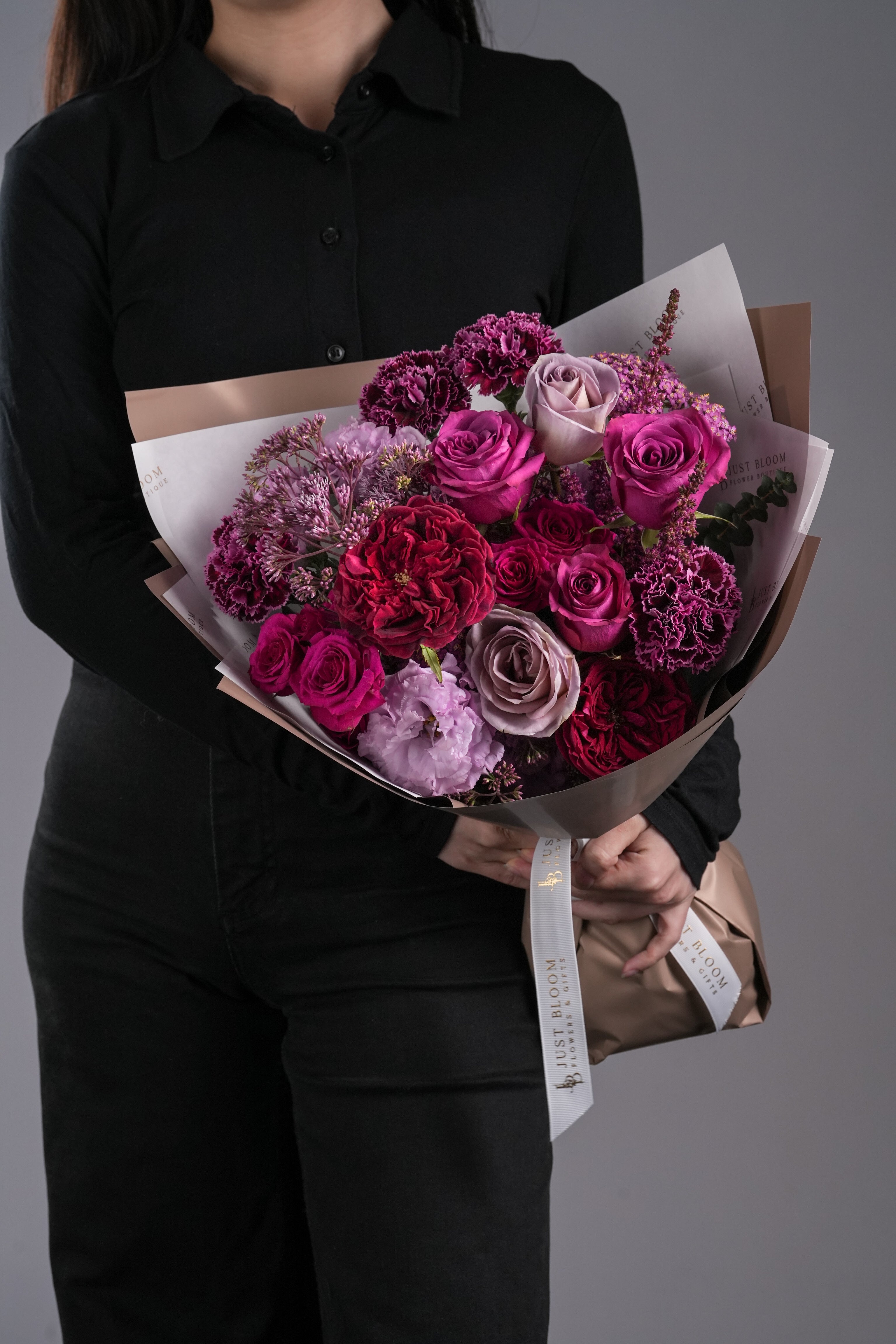 Miles bouquet in deep red and purple tones with luxurious garden roses and carnations