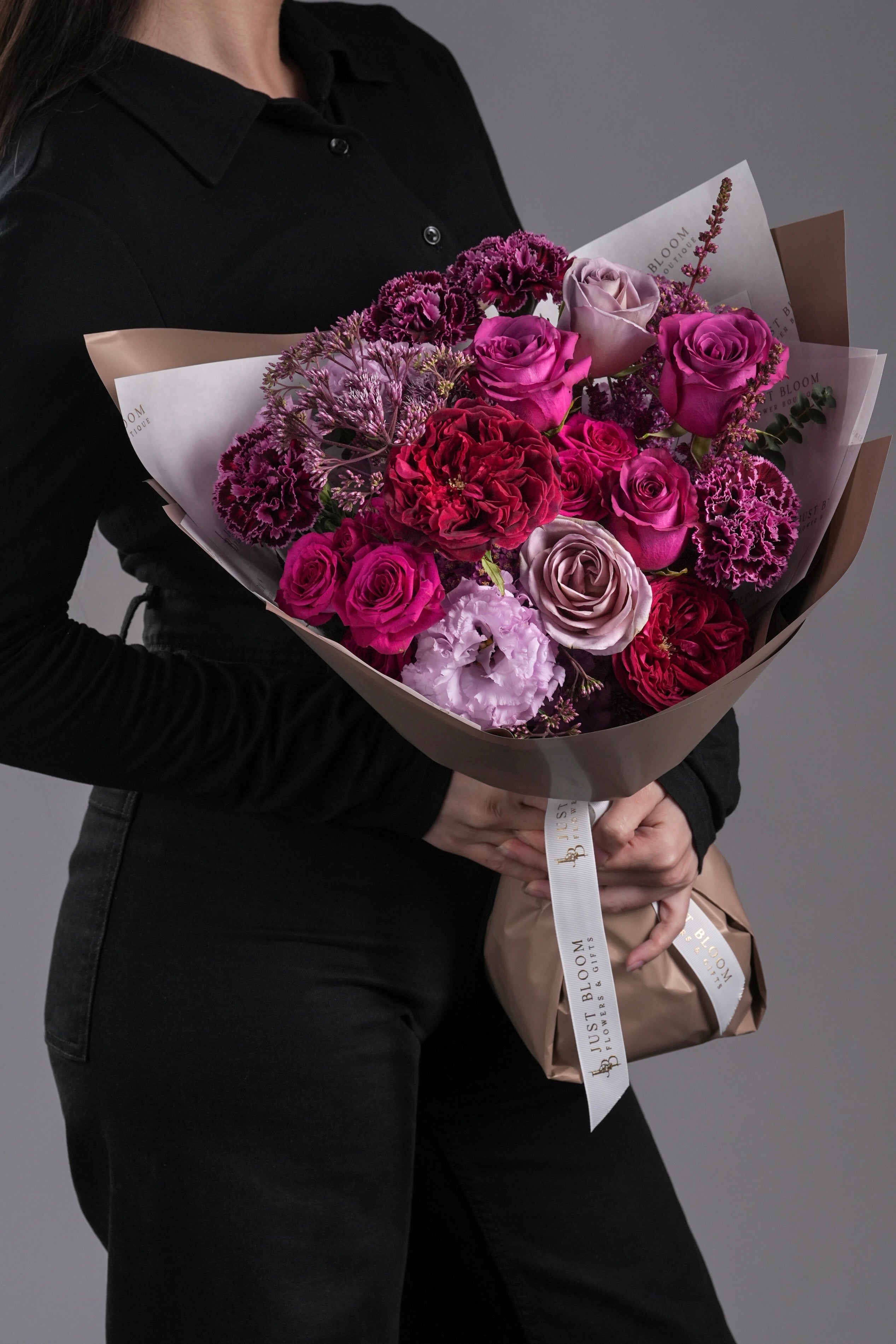 Miles bouquet with jewel-toned Ecuador roses, garden roses, carnations, and seasonal fillers