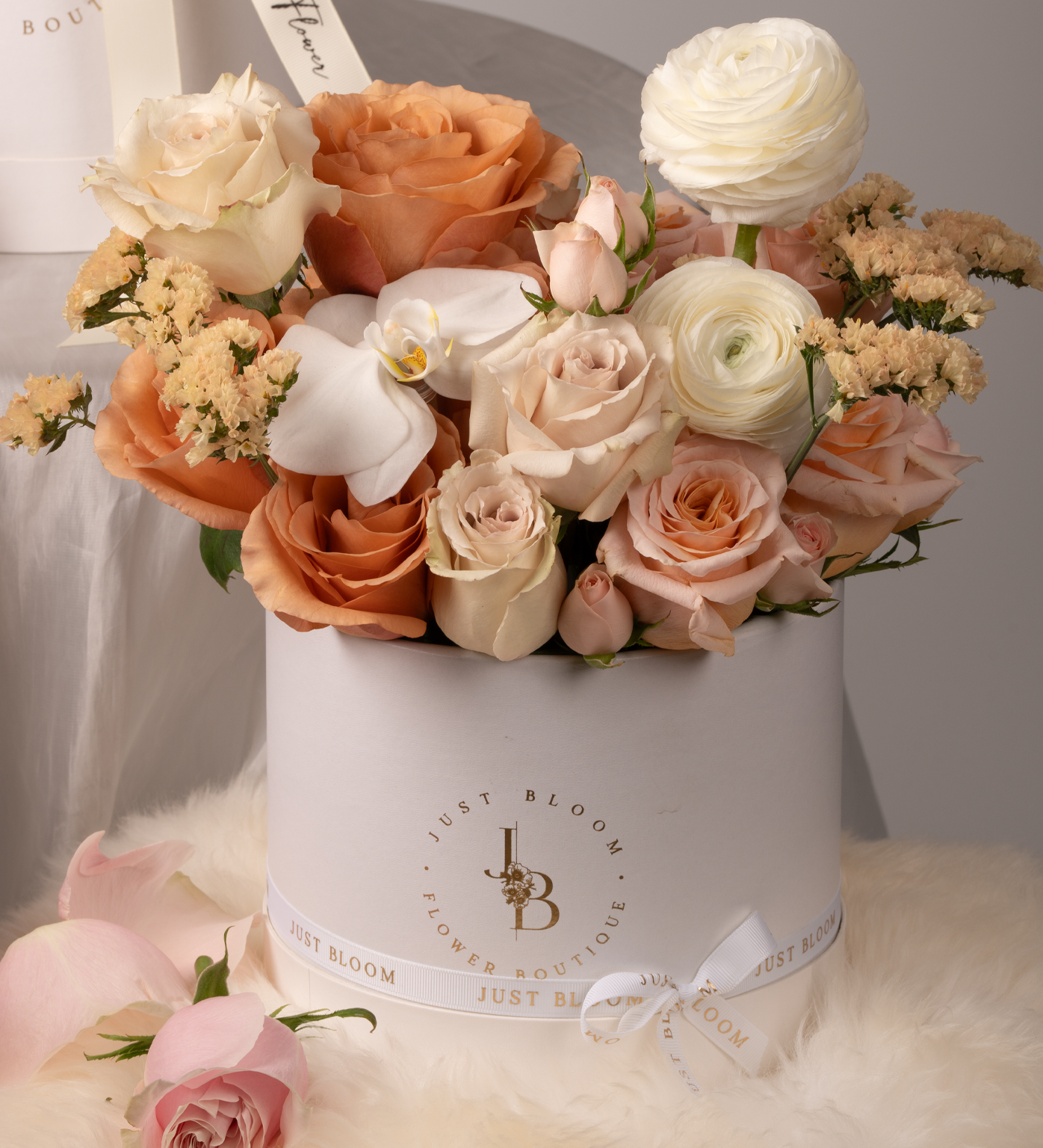 Miracle flower box with Ecuadorian roses, white orchids, and blush ranunculus