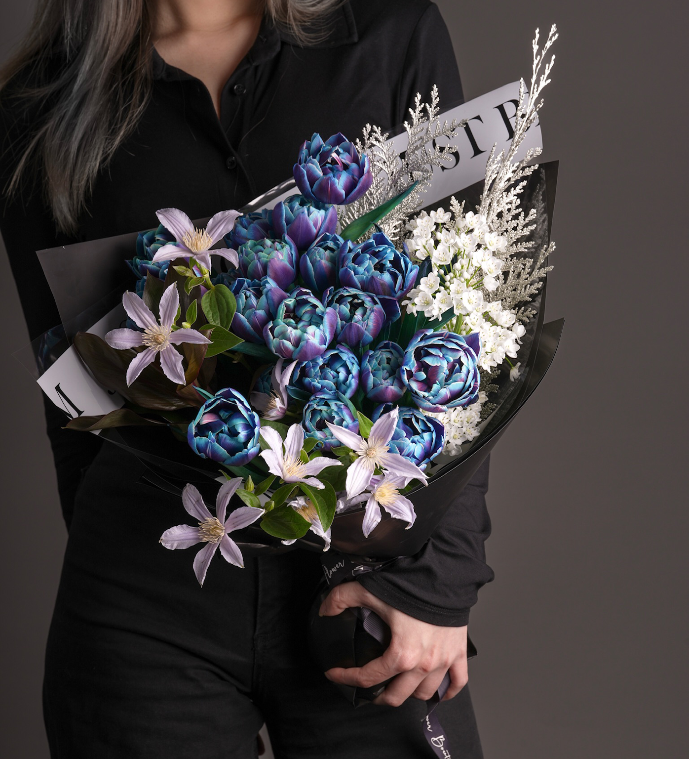 Miranda bouquet with tinted blue tulips, Clematis, and delicate white floral fillers