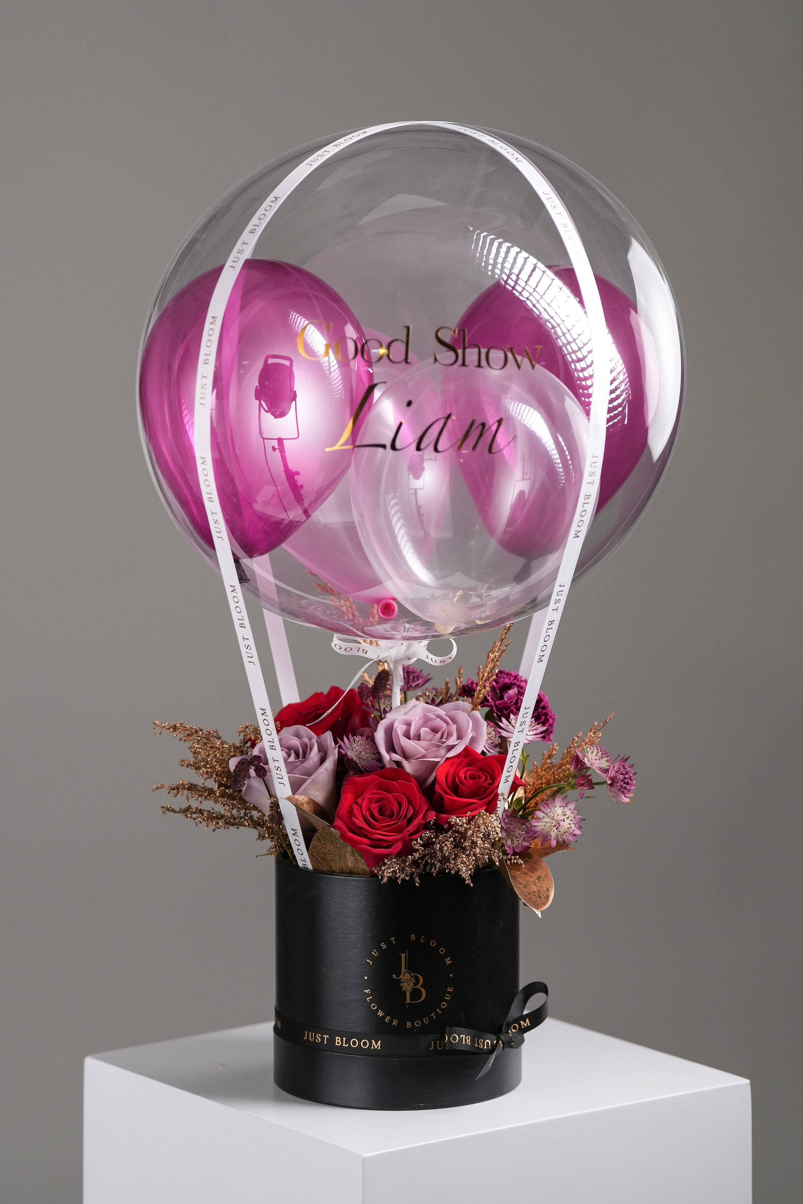 Mulberry balloon flower box with white garden roses, lady orchids and purple inner balloon