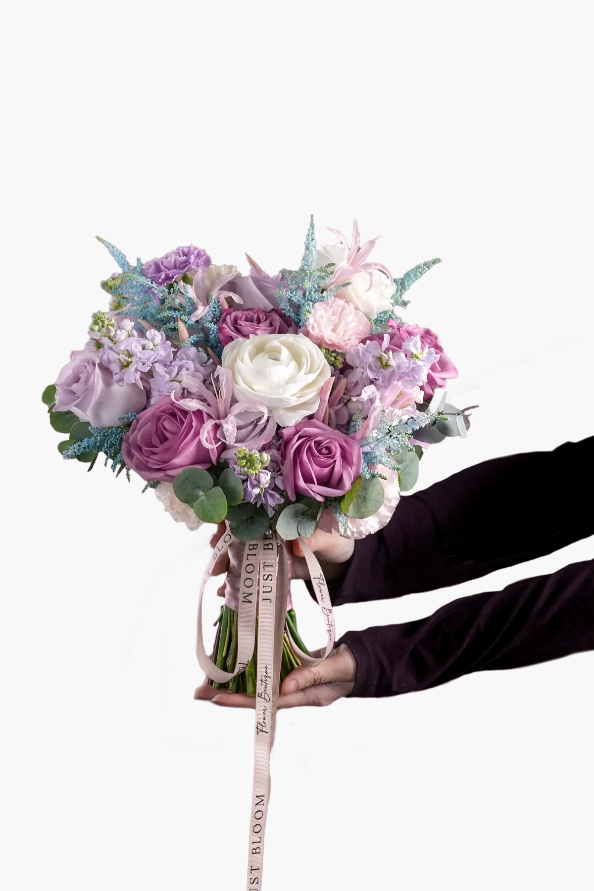 Naomi bouquet featuring purple Ecuadorian roses, white ranunculus and pastel Dutch fillers in mauve and lilac