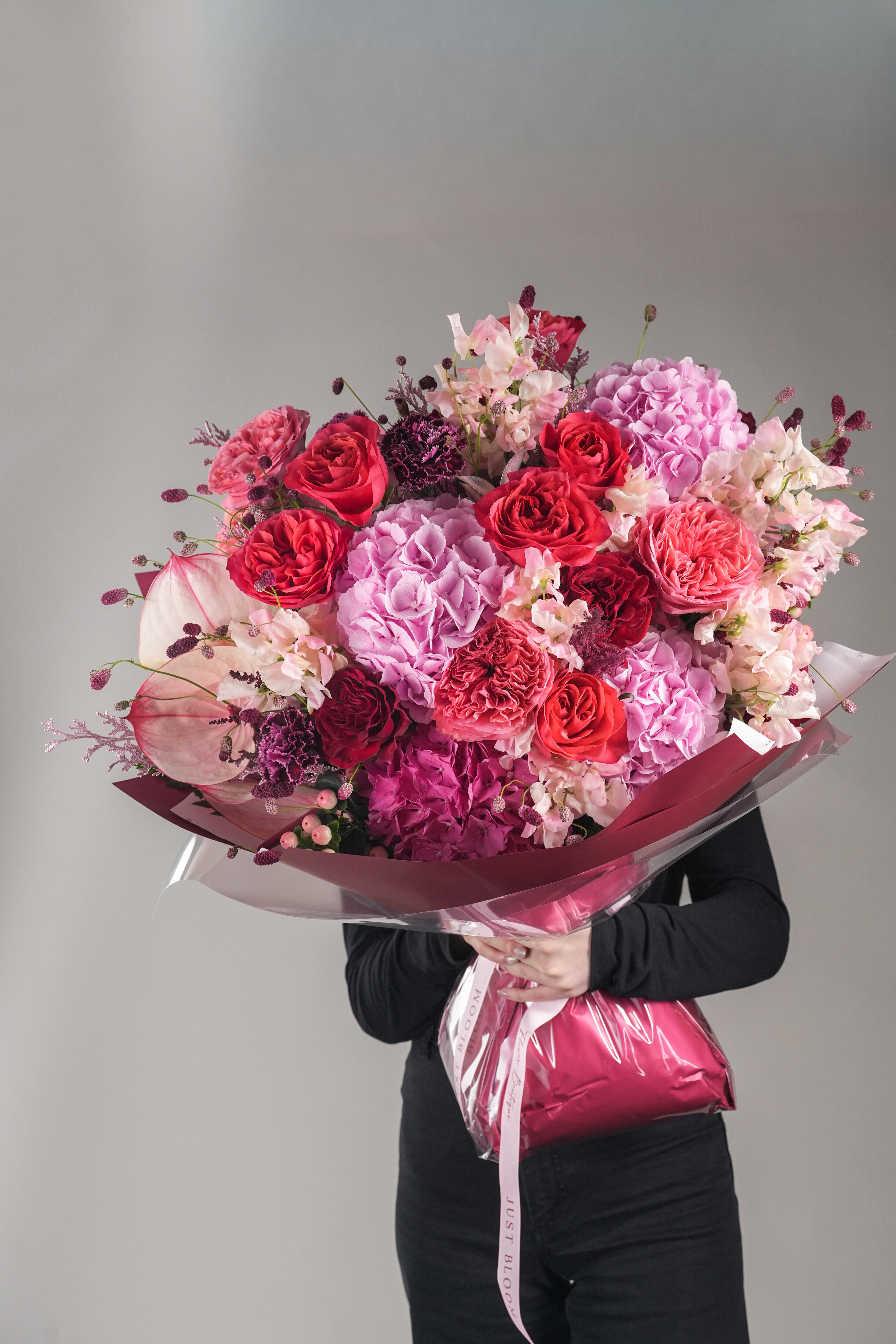 Nyla bouquet handheld with lush pink flowers including roses and hydrangeas